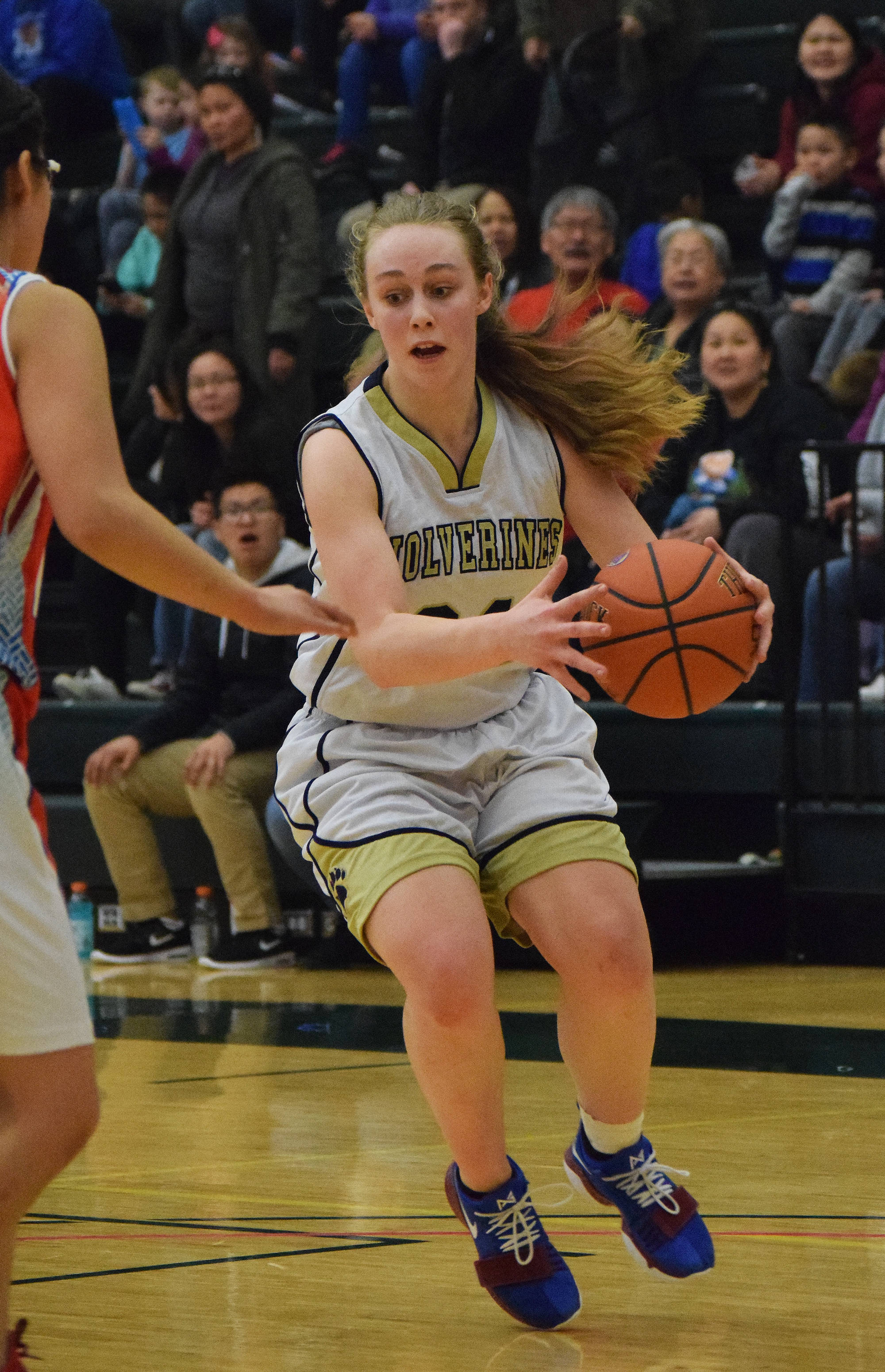 Ninilchik’s Isabella Koch dribbles past the top of the key Friday in a Class 1A state tournament consolation game against Toksook Bay at the Alaska Airlines Center in Anchorage. (Photo by Joey Klecka/Peninsula Clarion)