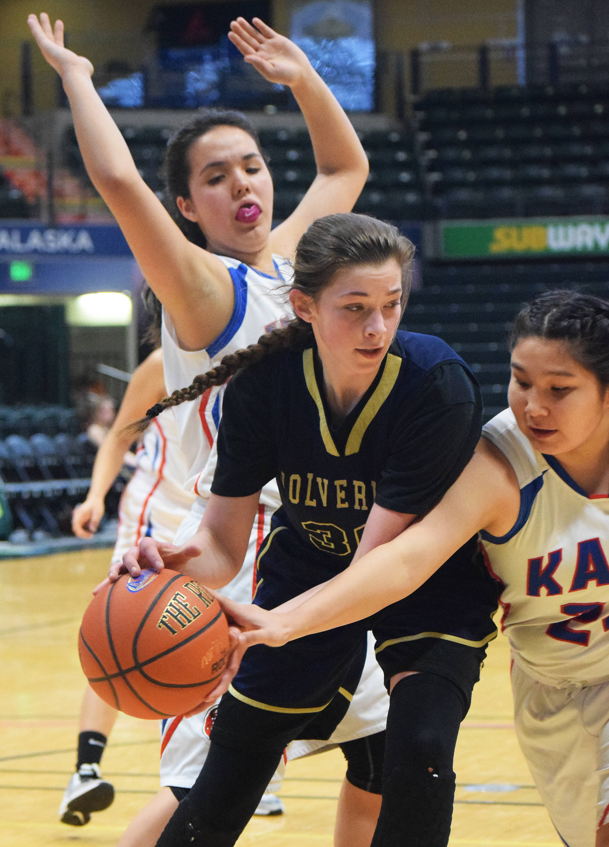 Ninilchik’s DeeAnn White battles for a rebound against Kake’s Felicia Ross-Shaquanie Saturday in the Class 1A girls state tournament fourth-place game at the Alaska Airlines Center in Anchorage. (Photo by Joey Klecka/Peninsula Clarion)