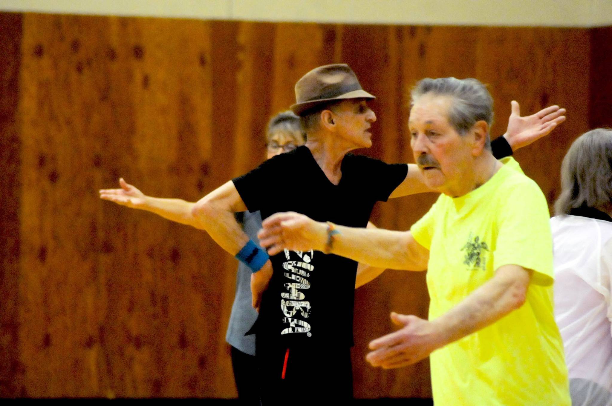 Zumba instructor Truman Krogel (center) leads a class at the Kenai Recreation Center on Thursday, March 15, 2018 in Kenai, Alaska. Krogel, 74, said he first tried Zumba himself four years ago, loved it and began teaching classes of his own in January 2017. (Photo by Elizabeth Earl/Peninsula Clarion)
