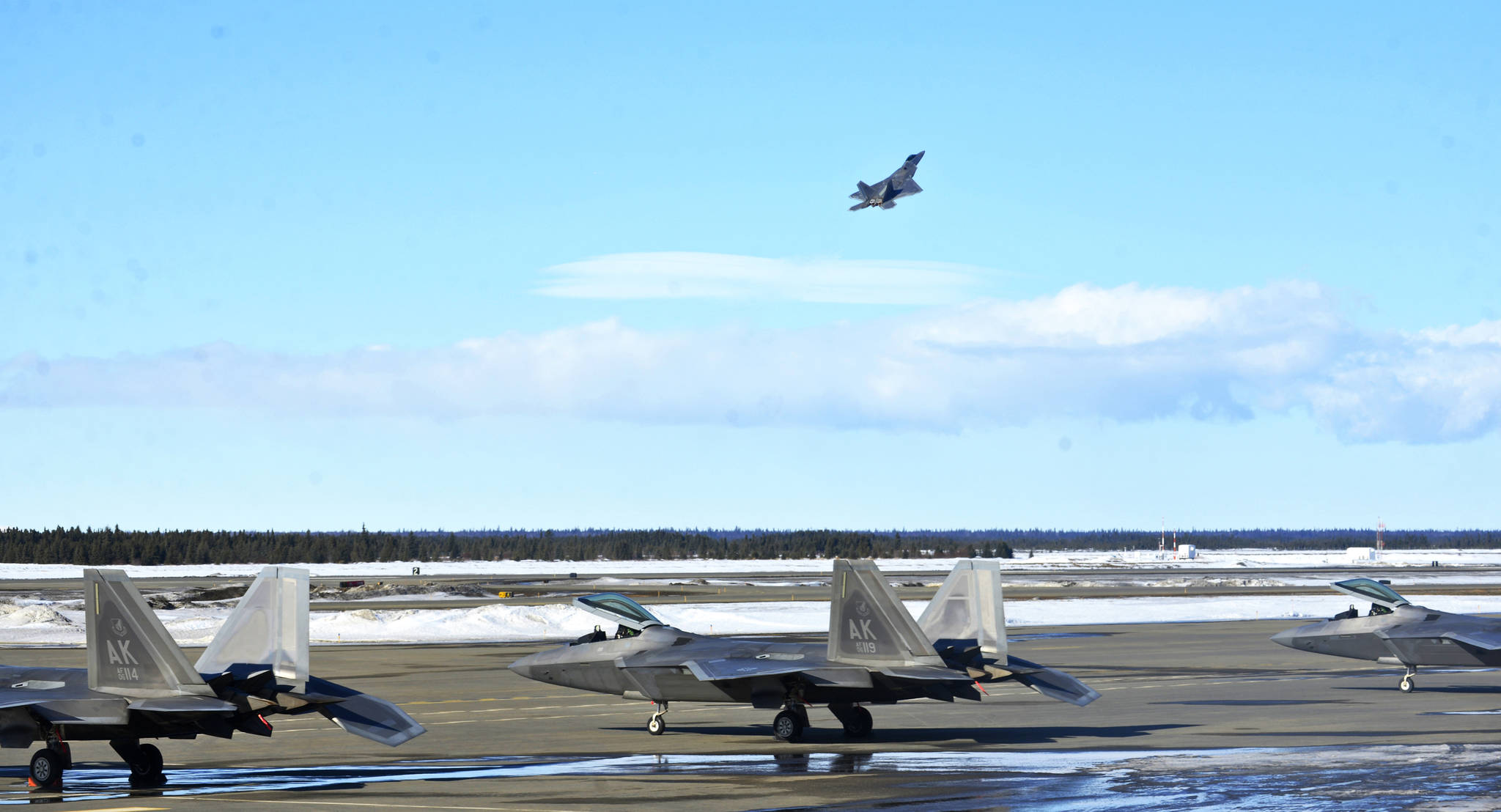 A U.S. Air Force F-22 “Raptor” fighter jet takes off from the Kenai Municipal Airport on Monday, March 19, 2018 in Kenai. Weather conditions stopped the fighters from landing at Joint Base Elmendorf-Richardson in Anchorage, their home field. Four of the F-22s belong to the 90th Fighter Squadron and four to the 525th Fighter Squadron, which were on separate training flights before landing in Kenai, said Major Stephen Montgomery, a pilot with the 90th. The fighters took off for Anchorage Monday afternoon. (Photo by Ben Boettger/Peninsula Clarion)