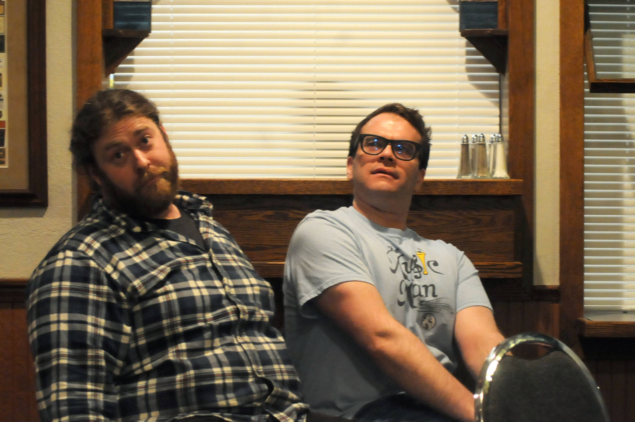 Chris Pepper (right) and Shaylon Cochran (left) stare into the distance during a rehearsal for Triumvirate Theatre’s production of “Forrest Guppy” on Tuesday, March 20, 2018 in Soldotna, Alaska. Pepper plays Forrest Guppy, a parody of the main character from the classic film “Forrest Gump,” in the comedy parody of the film. The theater troupe last put on the dinner theater production in 2010. (Photo by Elizabeth Earl/Peninsula Clarion)