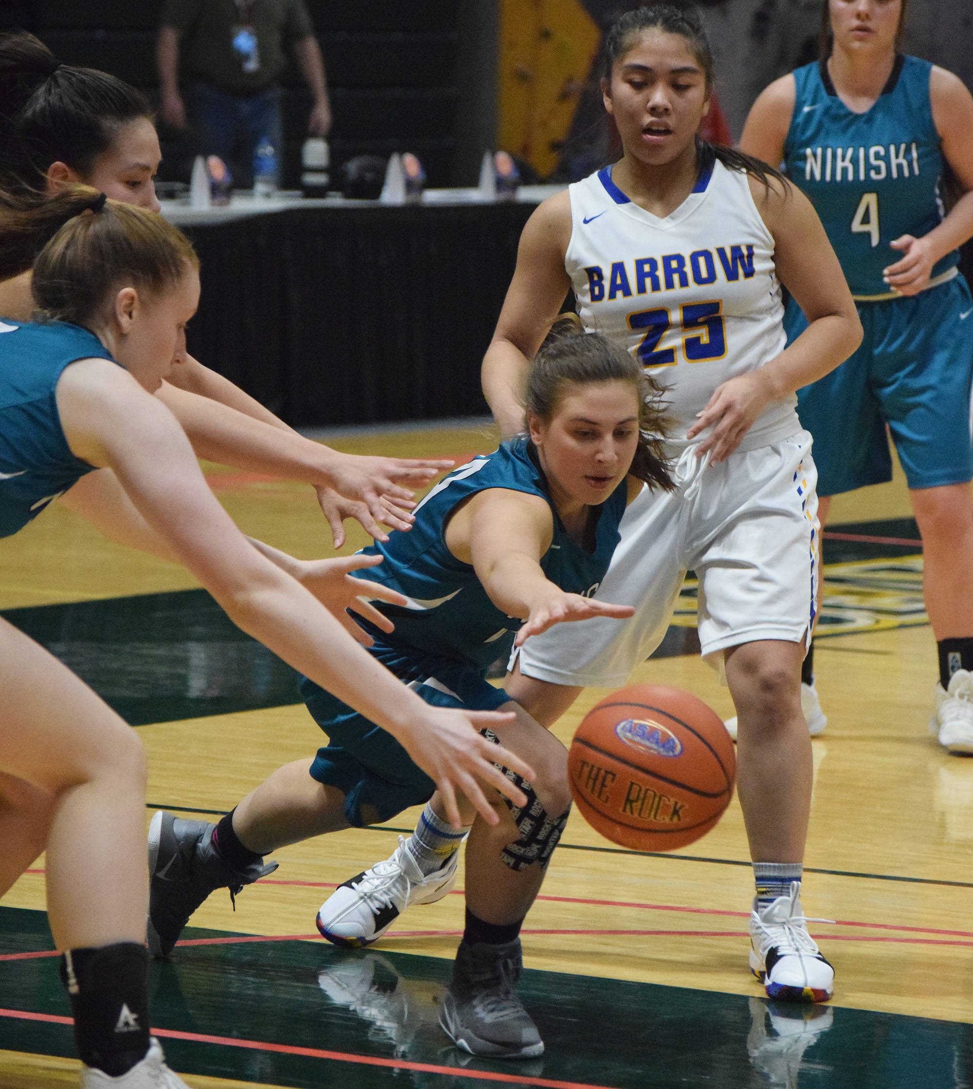 Nikiski’s Kelsey Clark dives for a loose ball Thursday evening in a quarterfinal contest against Barrow at the Class 3A state tournament at the Alaska Airlines Center. (Photo by Joey Klecka/Peninsula Clarion)