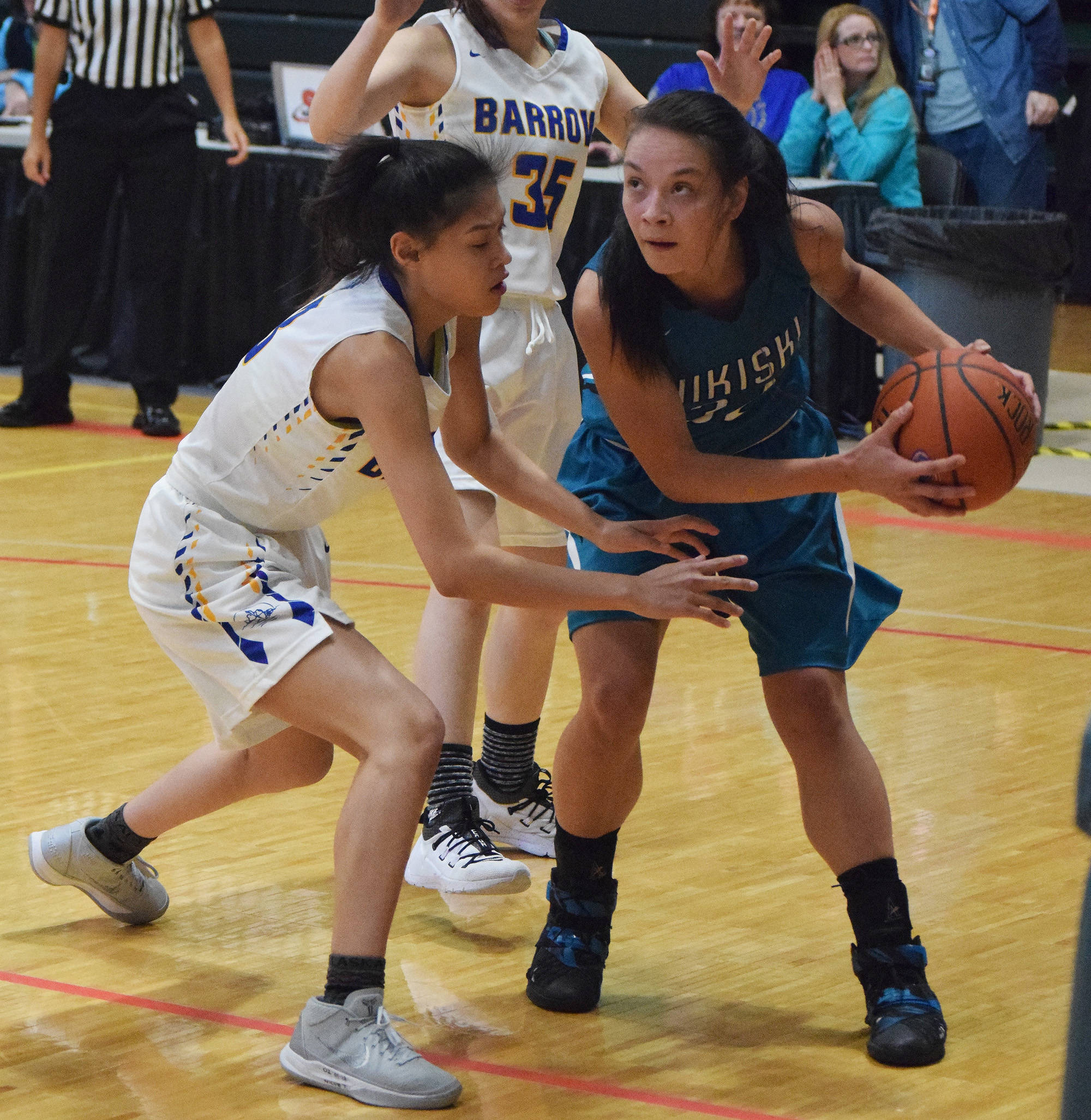 Nikiski’s Rylee Jackson (right) looks for space against Barrow’s Lewanne Brower, Thursday evening at the Class 3A state tournament at the Alaska Airlines Center. (Photo by Joey Klecka/Peninsula Clarion)