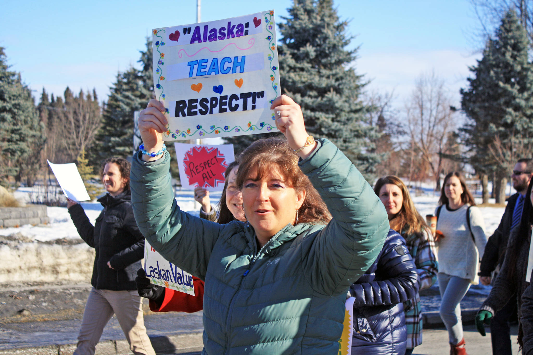 Marchers participate in the Alaskans Choose Respect Awareness Event, hosted by the LeeShore Center, on Wednesday, March 28 in Kenai. The march aimed to draw attention to the issue of sexual assault and domestic violence. (Photo by Erin Thompson/Peninsula Clarion)