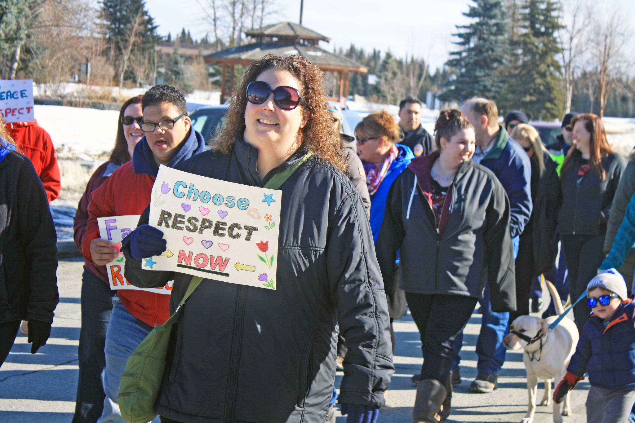 A participant in the Alaskans Choose Respect Awareness Event promotes the “choose respect” message during a march to the Kenai Visitor and Cultural Center in Kenai on March 28. Hosted by the LeeShore Center, the event aimed to bring awareness to the issue of domestic violence and sexual assault. (Photo by Erin Thompson/Peninsula Clarion)