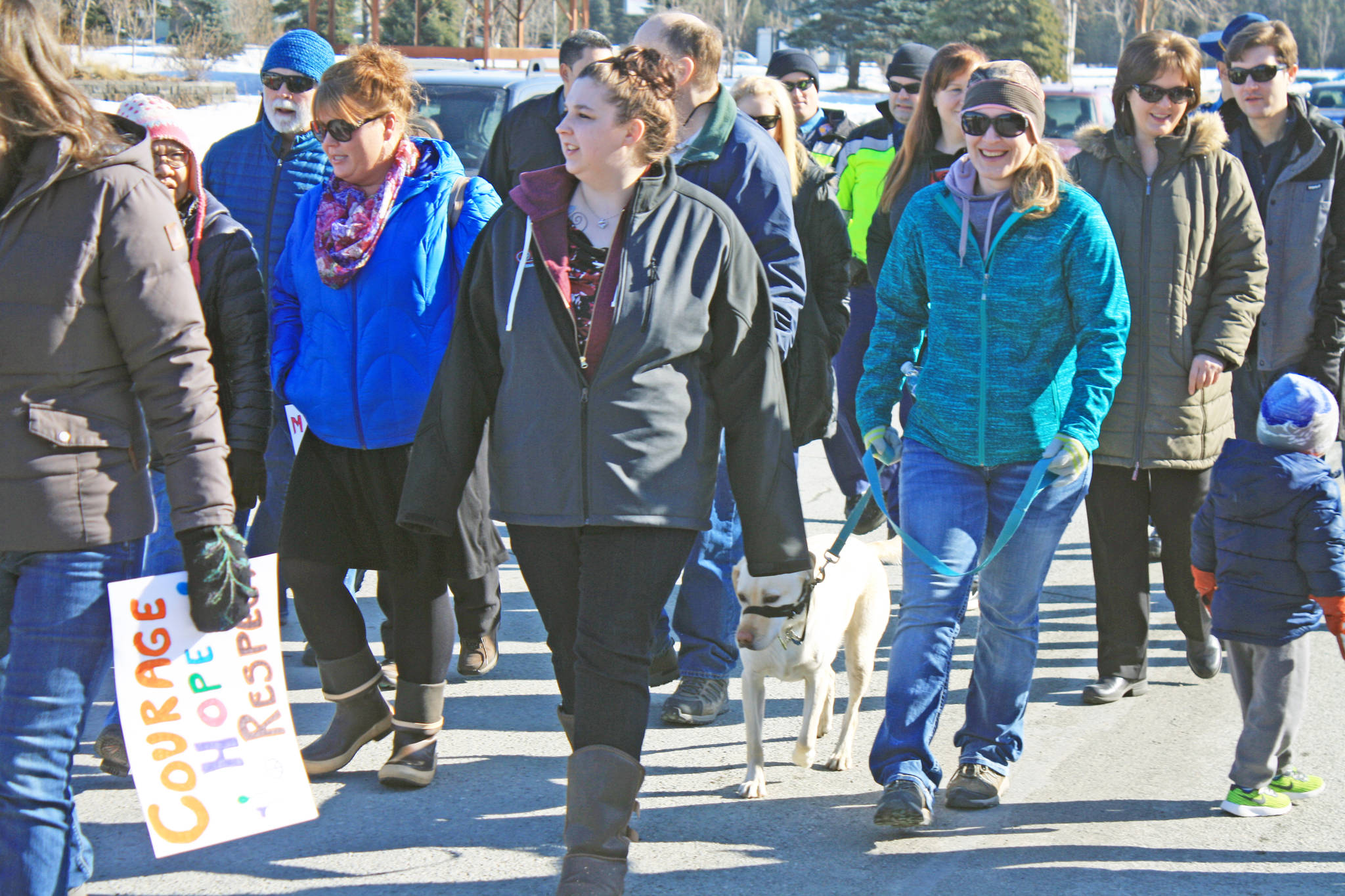 Marchers make their way along Frontage Road to the Kenai Visitor and Cultural Center as part of the Alaskans Choose Respect Awareness Event, hosted by the LeeShore Center on March 28. The event aimed to bring awareness to the issue of domestic violence and sexual assault. (Photo by Erin Thompson/Peninsula Clarion)