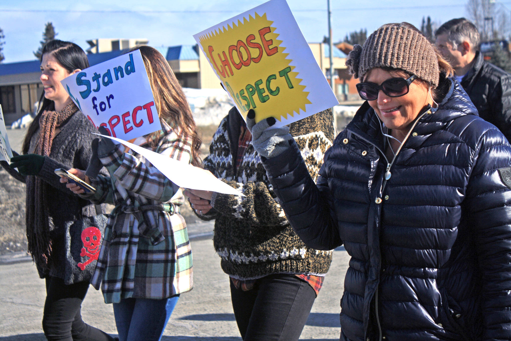 Marchers make their way along Frontage Road to the Kenai Visitor and Cultural Center as part of the Alaskans Choose Respect Awareness Event, hosted by the LeeShore Center on March 28. (Photo by Erin Thompson/Peninsula Clarion)