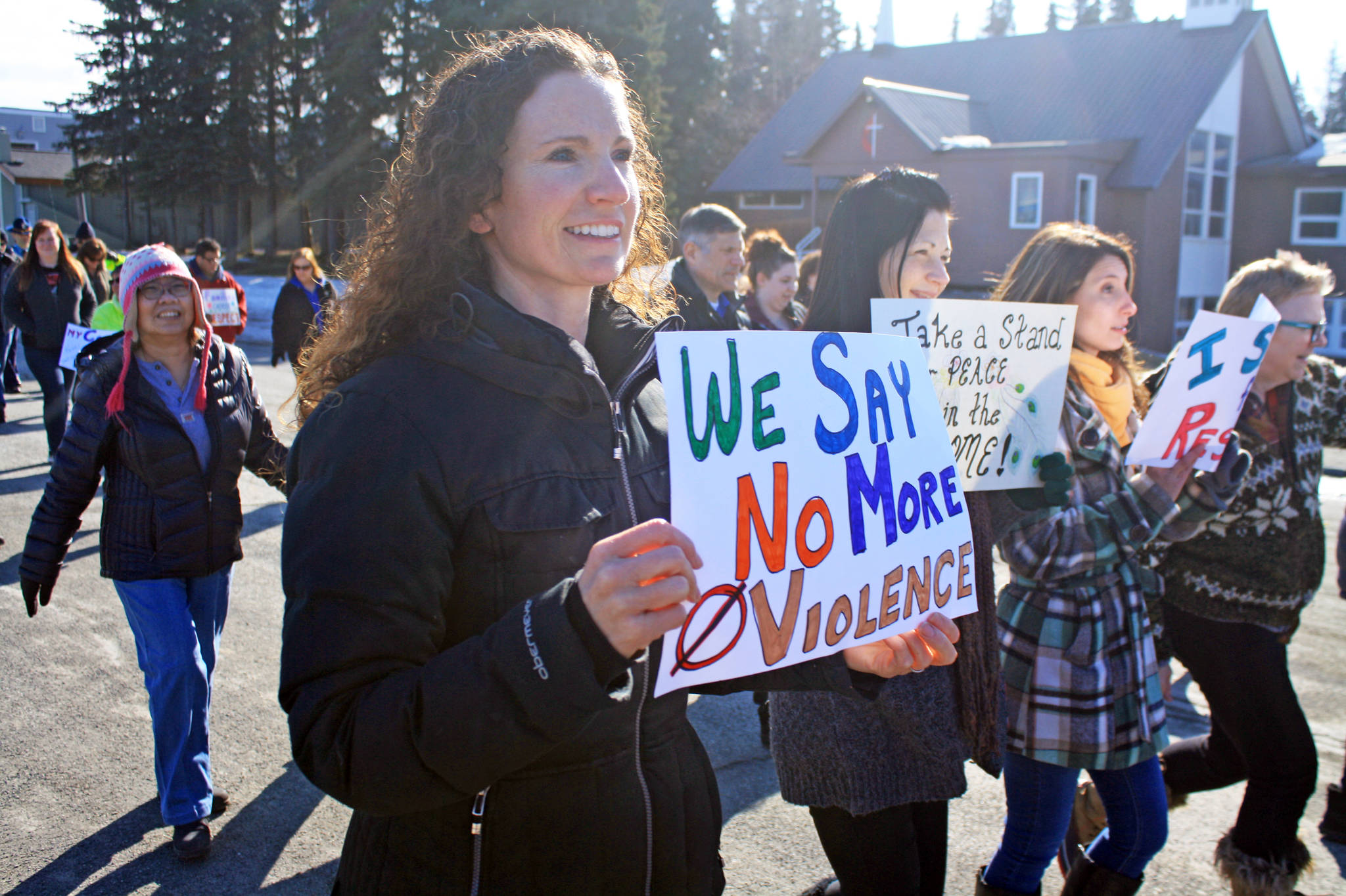 A woman protests against violence during the Alaskans Choose Respect Awareness Event, hosted by the LeeShore Center, on Wednesday, March 28 in Kenai. The march aimed to draw attention to the issue of sexual assault and domestic violence. (Photo by Erin Thompson/Peninsula Clarion)