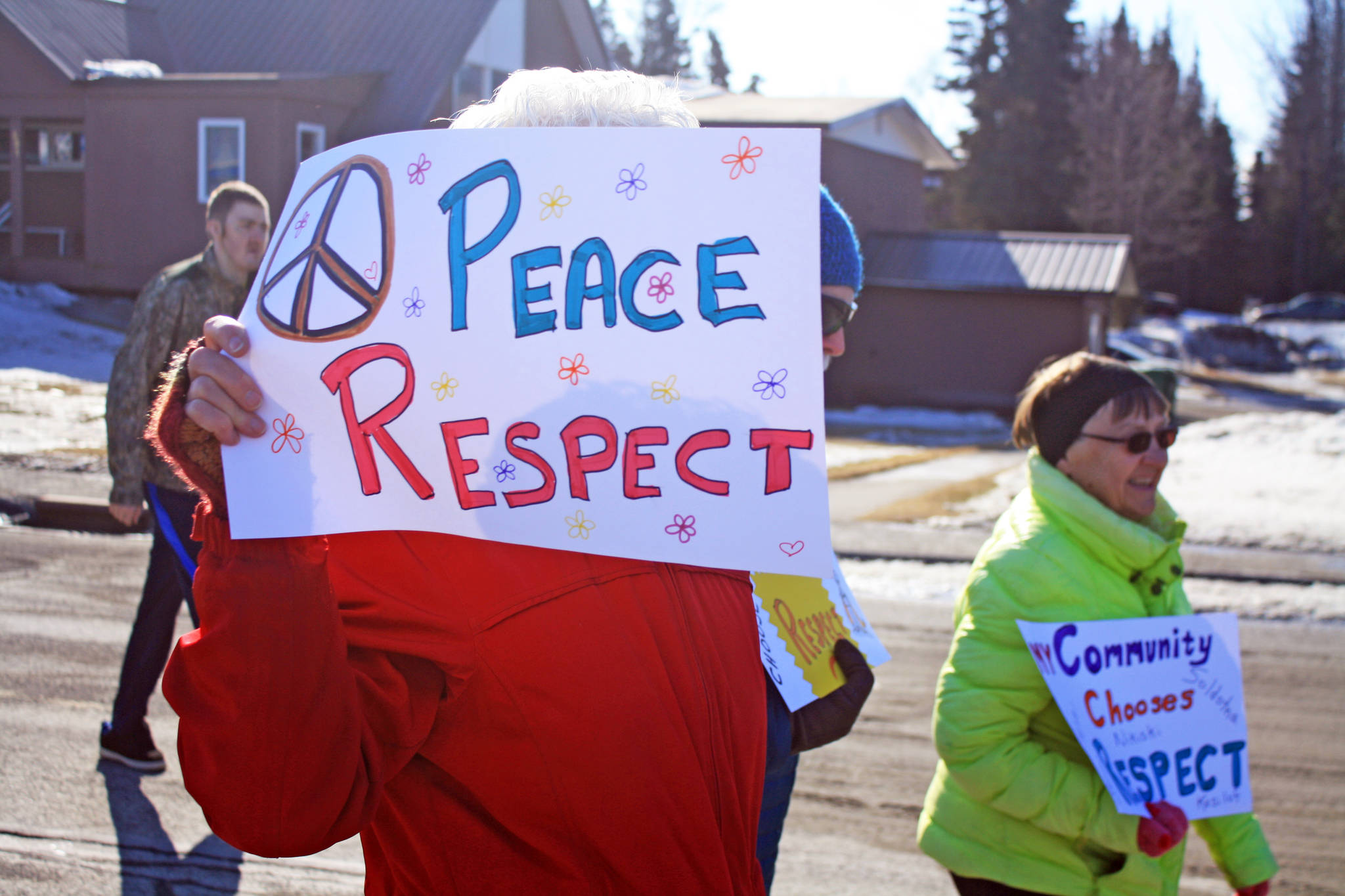 A woman holds a sign promoting respect during the Alaskans Choose Respect Awareness Event on March 28. Hosted by the LeeShore Center, the event aimed to bring awareness to the issue of domestic violence and sexual assault. (Photo by Erin Thompson/Peninsula Clarion)
