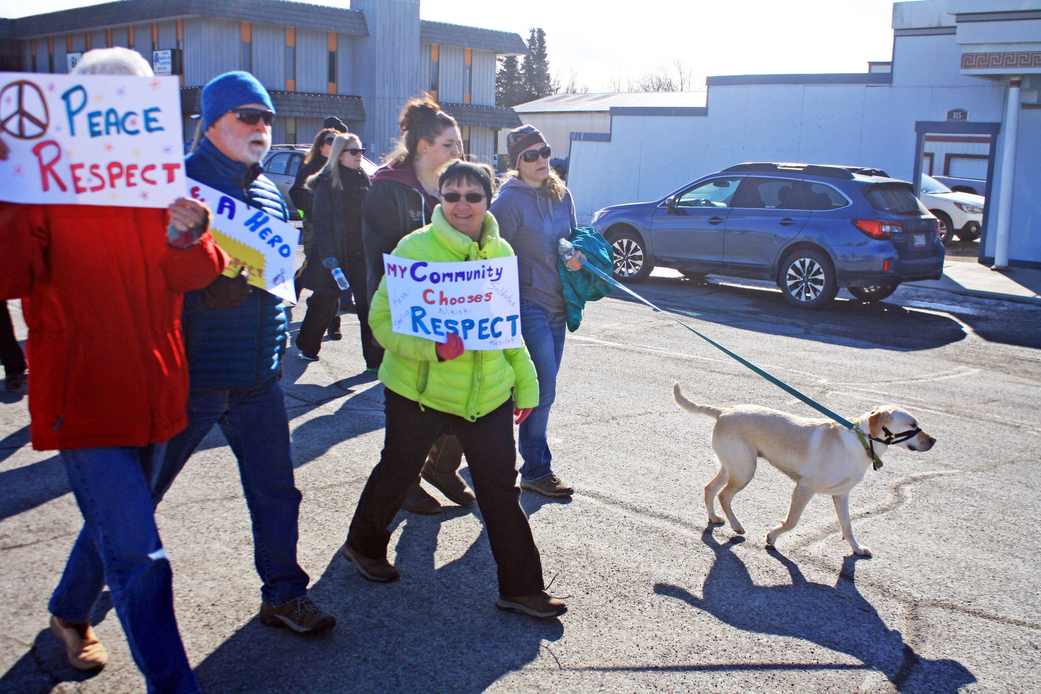 A dog leads the way during the Alaskans Choose Respect Awareness Event, hosted by the LeeShore Center, on Wednesday, March 28 in Kenai. The march aimed to draw attention to the issue of sexual assault and domestic violence. (Photo by Erin Thompson/Peninsula Clarion)