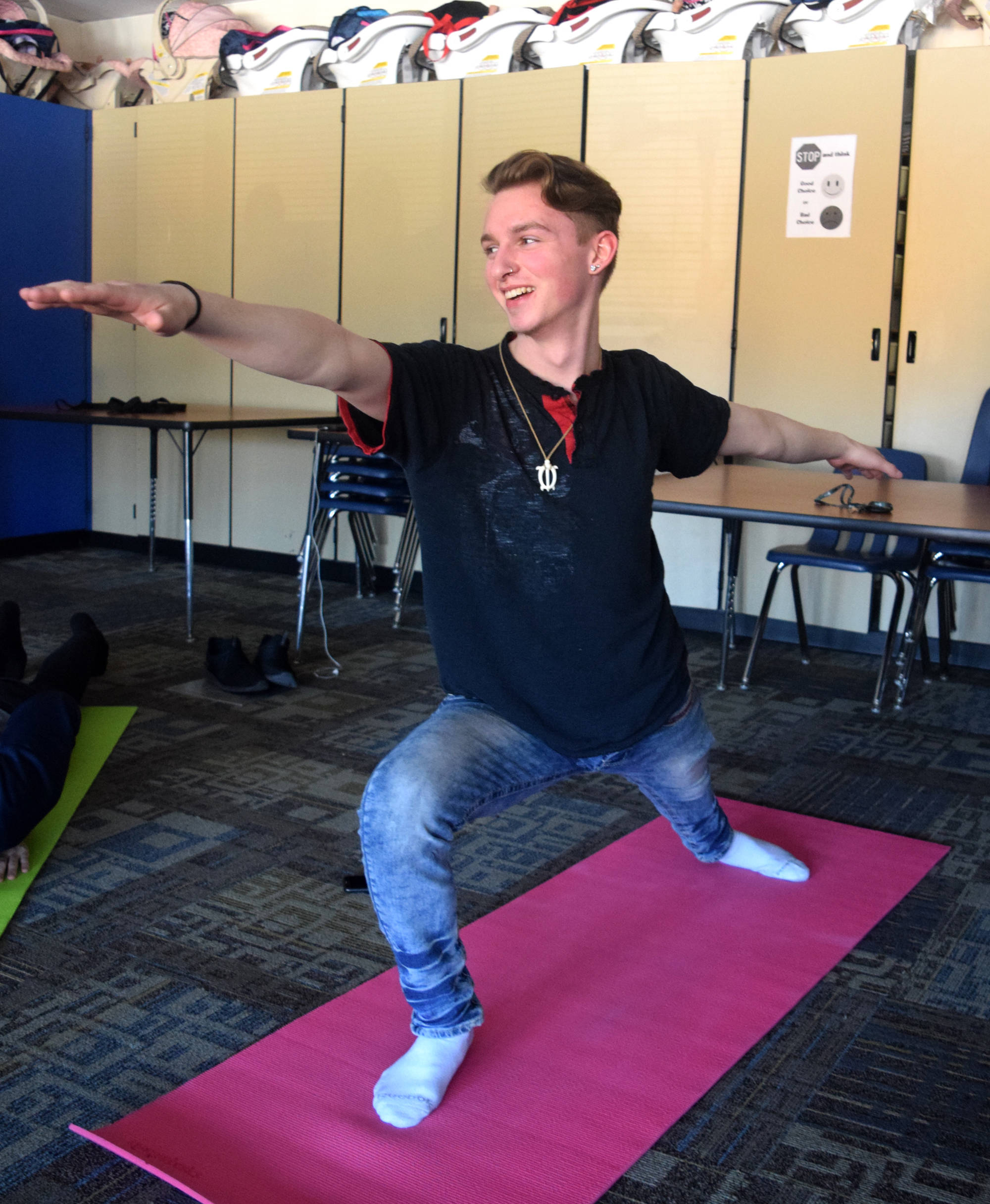 Cody Little practices yoga during the Focus on Learning class period at Soldotna High School on Friday. (Photo by Kat Sorensen/Peninsula Clarion)