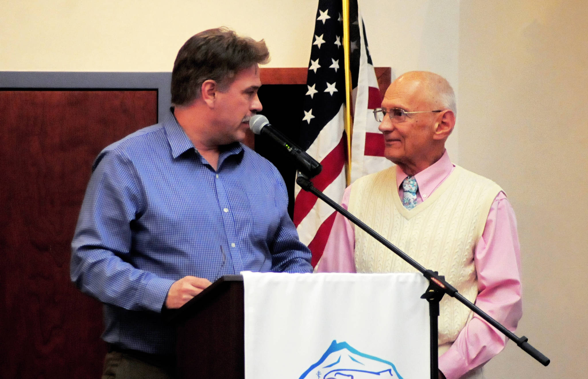 Kenai Mayor Brian Gabriel (left) talks with Dr. Peter Hansen (right) a retirement party for Hansen hosted by Peninsula Community Health Services at the Kenai Visitors and Cultural Center on Thursday, March 29, 2018 in Kenai, Alaska. Hansen arrived in Kenai in 1967 and has practiced family medicine since in private practice, with Central Peninsula Hospital and with Peninsula Community Health Services. He plans to retire but to stay in the community and work on a book about his experiences. (Photo by Elizabeth Earl/Peninsula Clarion)
