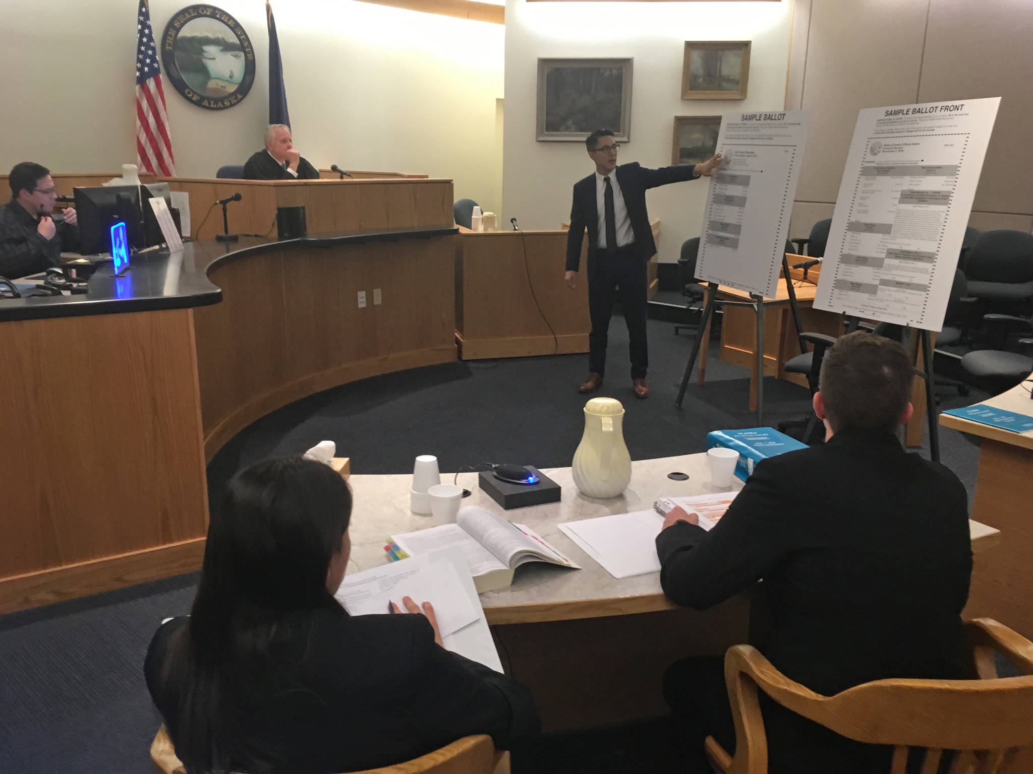 State attorneys Elizabeth Bakalar, foreground left, and Margaret Paton-Walsh, foreground right, listen to arguments made by attorney Jon Choate on Thursday, Sept. 21, 2017 in Alaska Superior Court in Juneau. At background left is Judge Philip Pallenberg, who is expected to decide the Alaska Democratic Party’s lawsuit against the state next week. (James Brooks | Juneau Empire File)