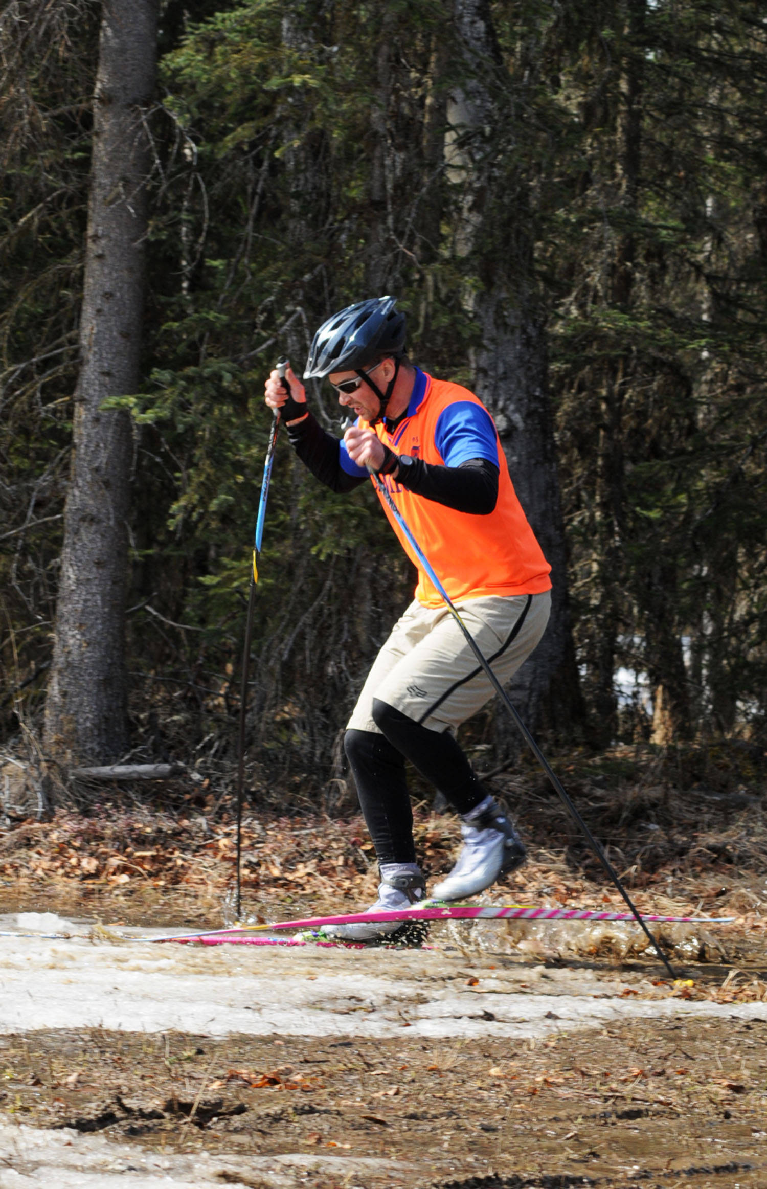 Anthony Murray hops his skis through a muddy section of the Wolverine Trail during the 2018 Choose Your Weapon race at Tsalteshi Trails on Sunday, April 15, 2018 in Soldotna, Alaska. Racers completed two 5-kilometer laps around the lower trails by running, biking or skiing, with the option of switching between laps for extra points. Most of the trails had some snow with patches of wet mud sprinkled throughout as spring temperatures begin to dominate the central Kenai Peninsula. (Photo by Elizabeth Earl/Peninsula Clarion)
