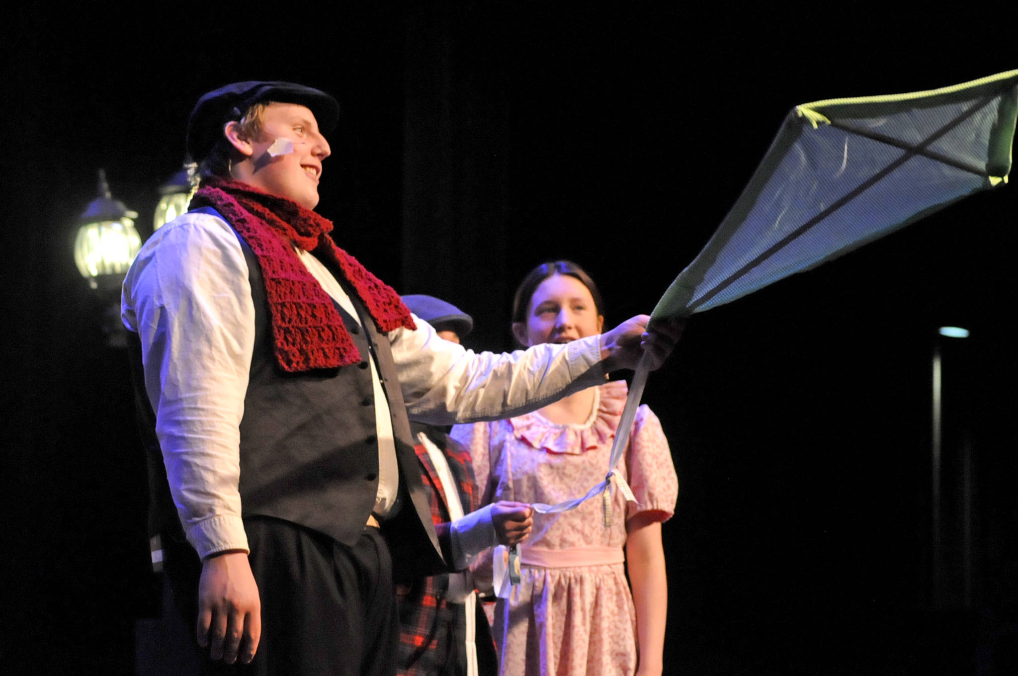 TOP: Bert (played by Ethan Hack) tells Jane (Leora McCaughey) and Michael Banks (Brynne Tedford) about flying kites during a dress rehearsal for Nikiski Middle-High School’s production of “Mary Poppins” on Monday in Nikiski.