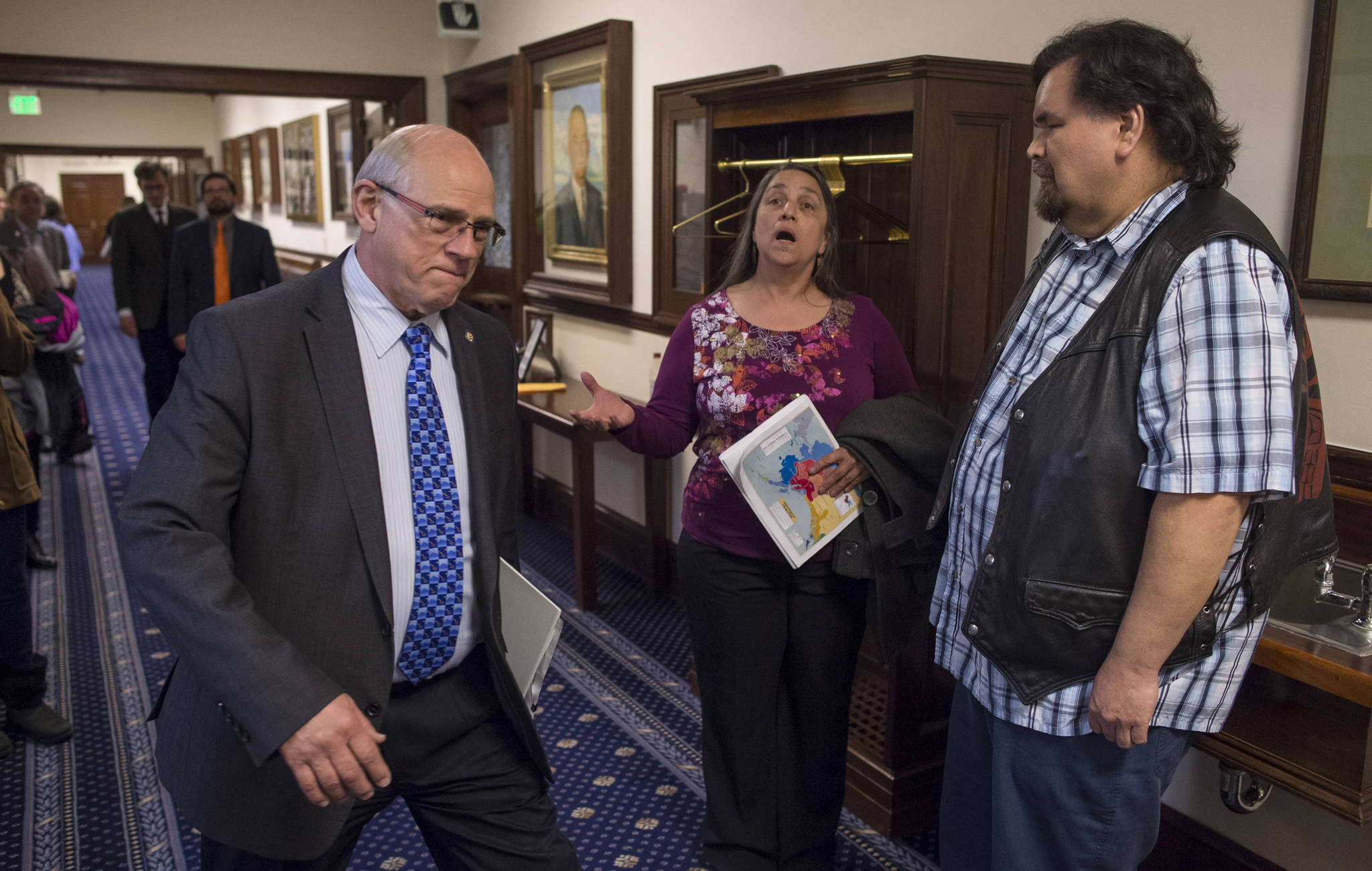 Nancy Keen, center, and Alfie Price, right, sing a Nisga’a prayer song as senators, including Sen. John Coghill, R-North Pole, make their way to the Senate chambers for a session on Wednesday, April 25, 2018. Senators were to vote on a resolution urging Gov. Bill Walker to issue an administrative order recognizing a linguistic emergency for Alaska Native languages. (Michael Penn | Juneau Empire)