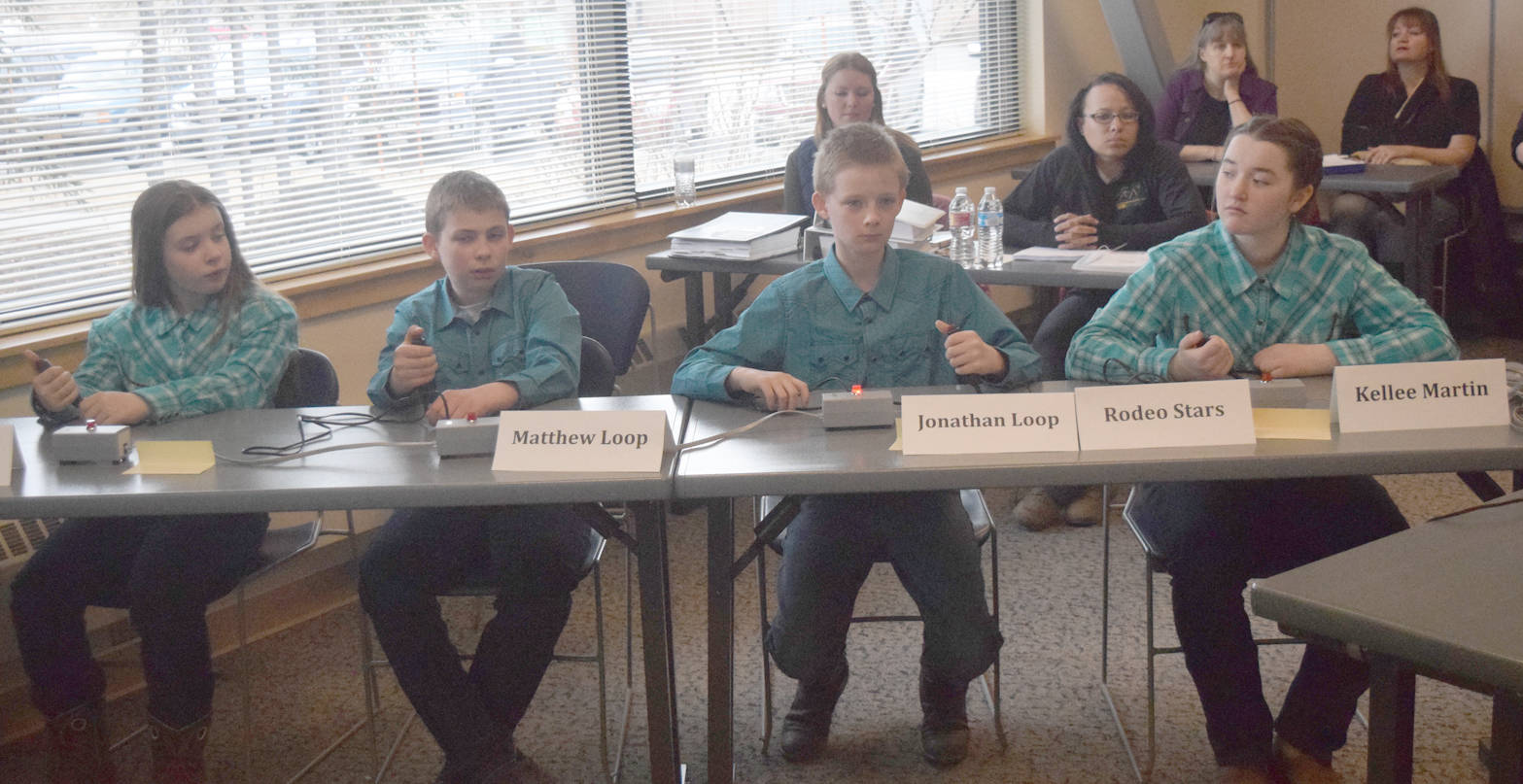 The Rodeo Stars, made up of Emily Grimm, Matthew Loop, Jonathan Loop and Kellee Martin, prepare to compete in a quiz game called buzzer bowl Saturday, April 21, 2018, in the Alaska State Horse Contest at Kenai Peninsula College’s Kenai River Campus. (Photo by Jeff Helminiak/Peninsula Clarion)