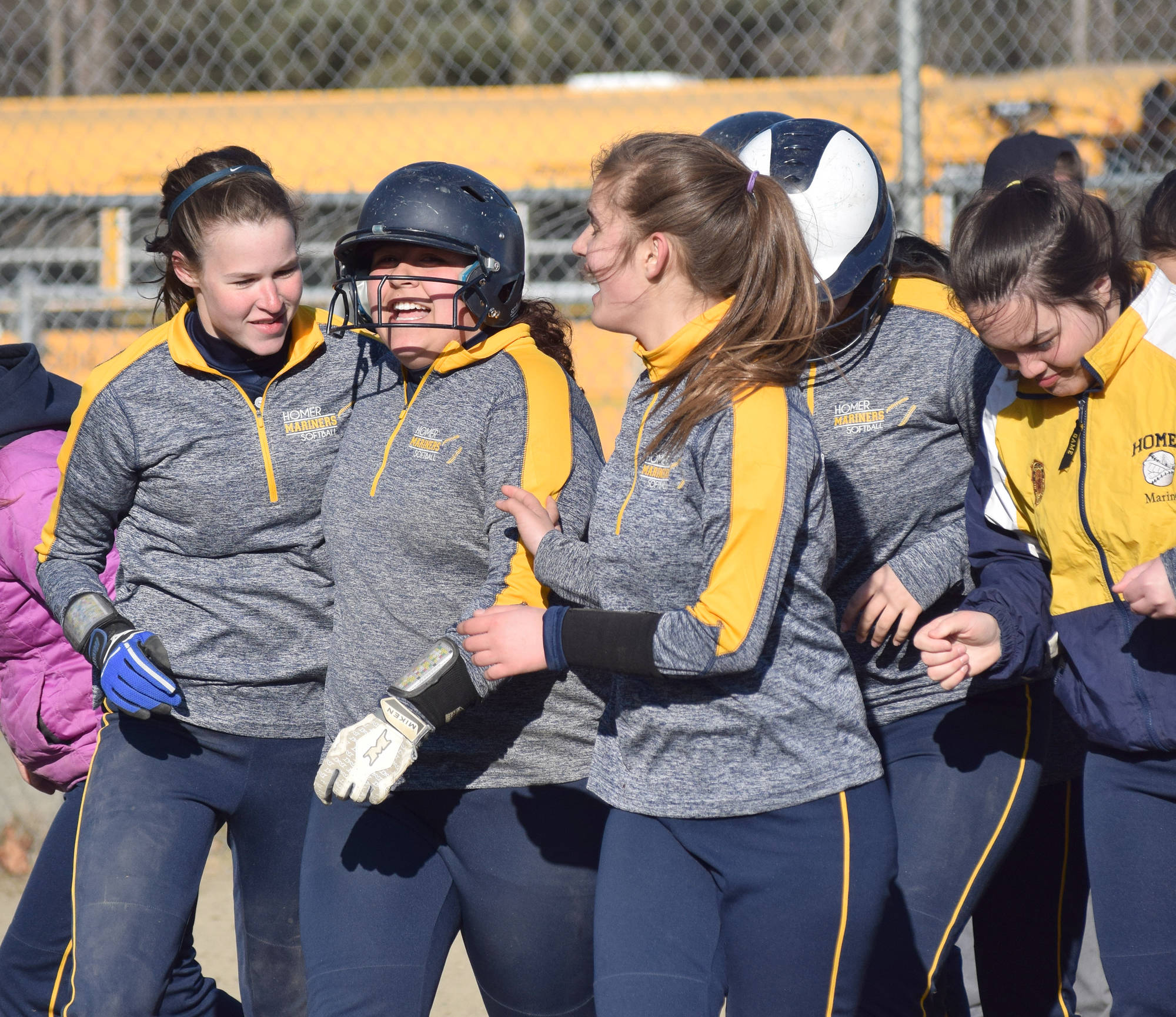 Homer junior Brianna Hetrick (second from left) celebrates with her teammates after touching home plate following a home run Tuesday evening at the Soldotna Little League fields. (Photo by Joey Klecka/Peninsula Clarion)