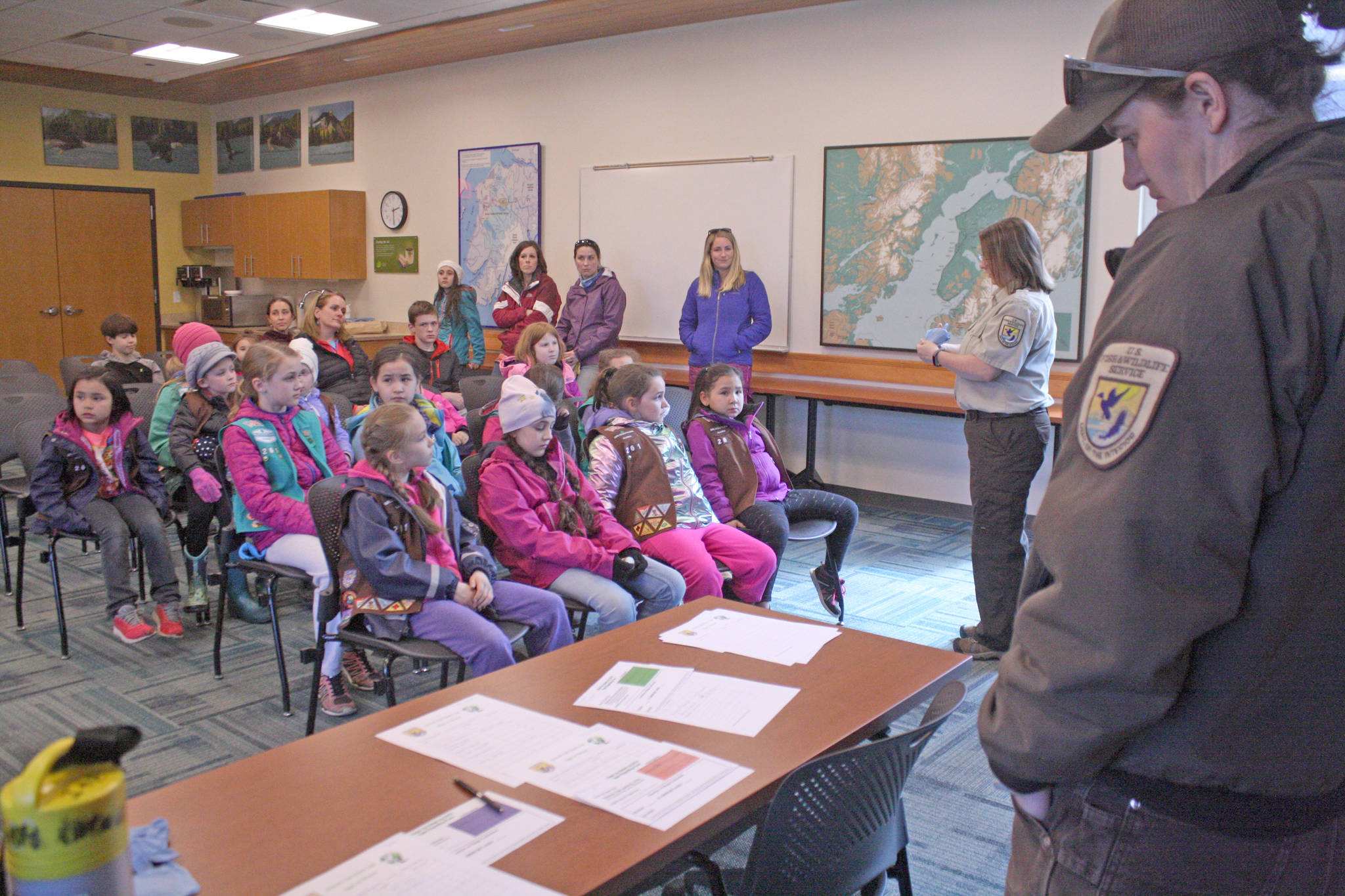 Park Ranger Leah Eskelin, far right, instructs volunteers how to safely pick up trash ahead of the Kenai National Wildlife Refuge’s Green Up, Clean Up event hosted on May 2, 2018. Approximately 45 people, including three Girl Scout troops, spent the afternoon picking up trash as part of a week-long effort by refuge staff to rid roadways of refuse accumulated during the winter months. (Photo by Erin Thompson/Peninsula Clarion)