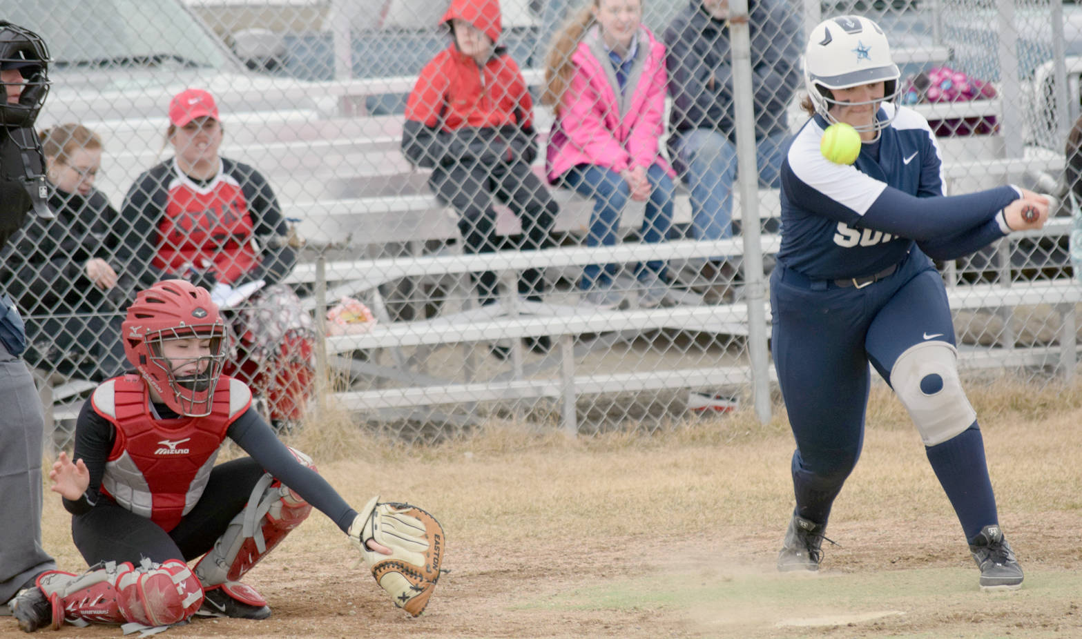 Soldotna’s Bailey Smith pounds the ball into the ground Thursday, May 3, 2018, at Steve Shearer Memorial Ball Park in Kenai. Kenai Central catcher Alyssa Stanton would pop up and toss Smith out at first base. (Photo by Jeff Helminiak/Peninsula Clarion)