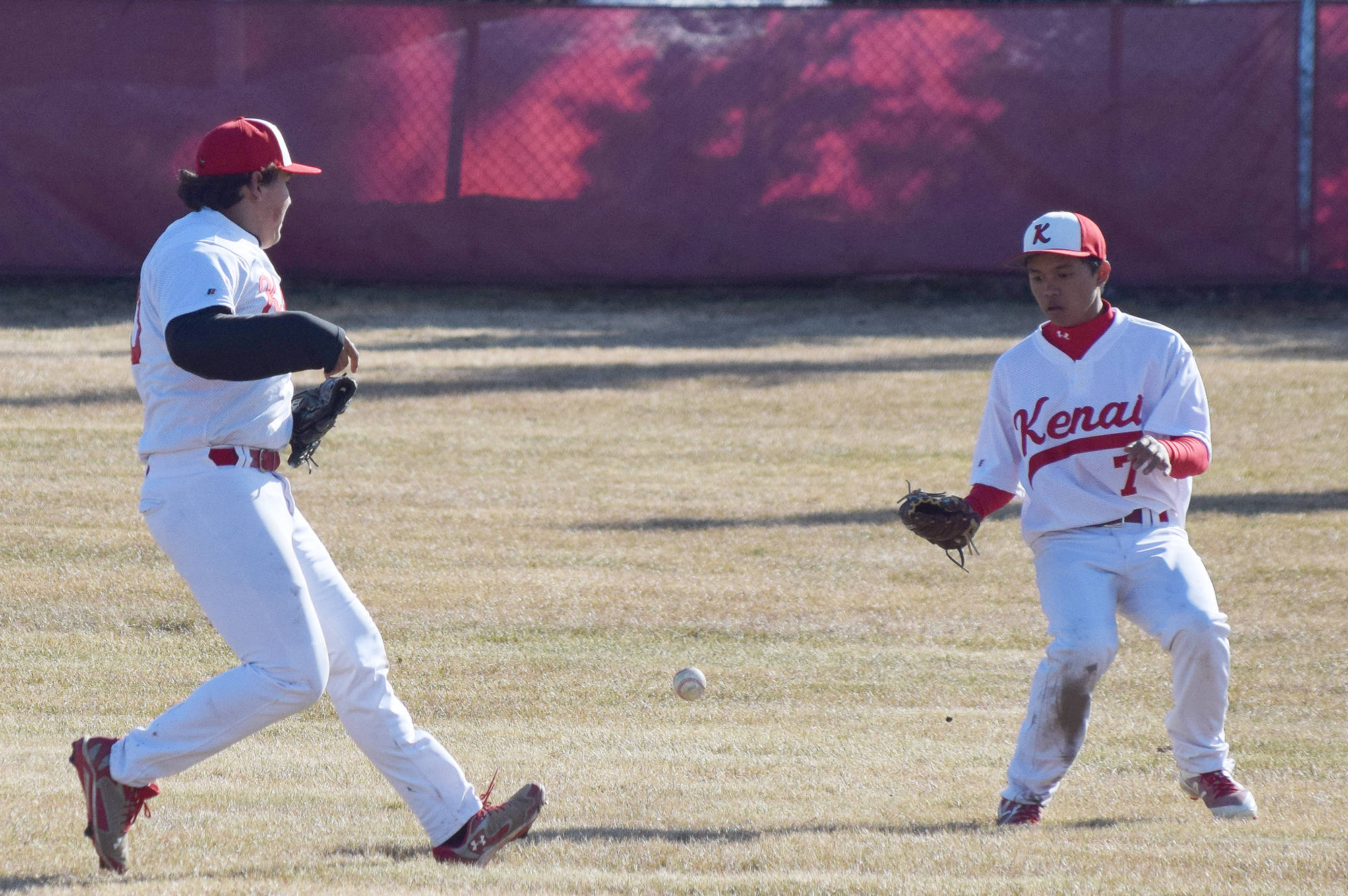 Kenai Central outfielders Manny Noriega and Harold Ochea (7) converge on a bloop single from a Kodiak batter Friday at the Kenai Little League Fields. (Photo by Joey Klecka/Peninsula Clarion)