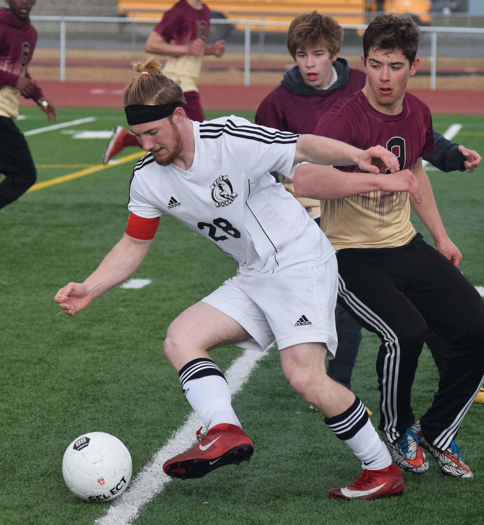 Kenai’s Rykker Riddall wards off Grace Christian’s Kevin Leach Saturday at Kenai Central High School. (Photo by Joey Klecka/Peninsula Clarion)