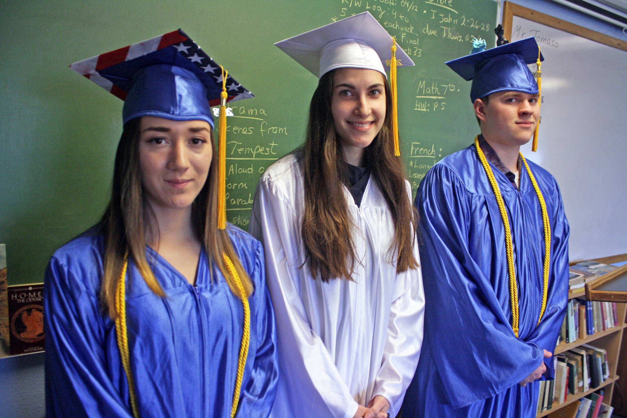 From left, Breona Michele DeLon, Chanelle Frances Usvat and Gabriel Nicholas Bignell prepare for their graduation at Cook Inlet Academy on Sunday, May 6. (Photo by Erin Thompson/Peninsula Clarion)
