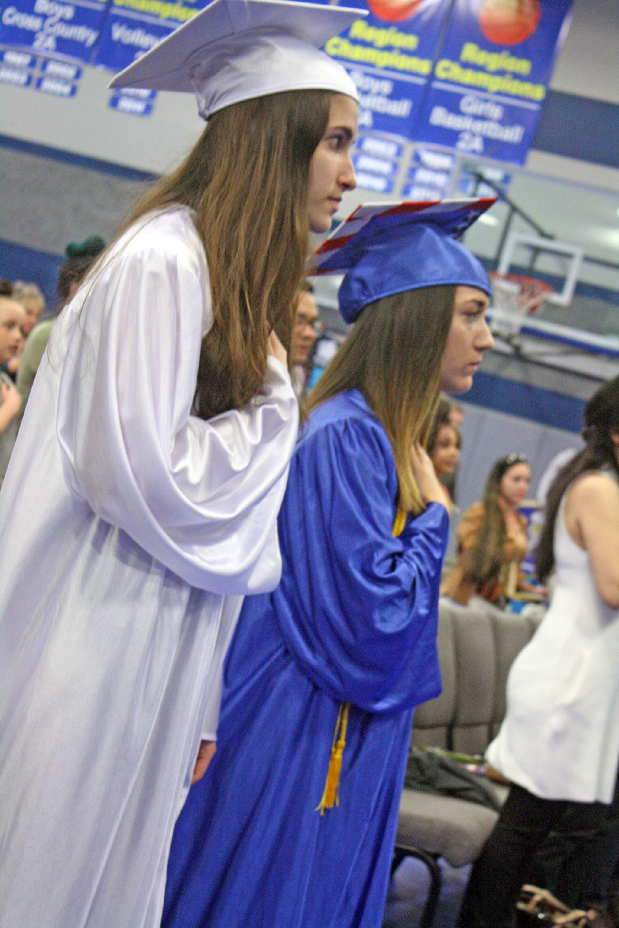 Chanelle Frances Usvat, left, and Breona Michele DeLon participate in their high school graduation ceremony at Cook Inlet Academy in Soldotna, Alaska, on Sunday, May 6.