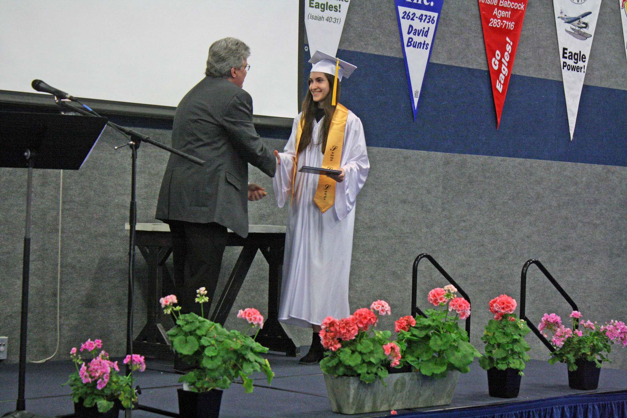 Chanelle Frances Usvat accepts her diploma from Cook Inlet Academy in Soldotna, Alaska, on Sunday, May 6. Usvat, who graduated summa cum laude, plans to attend the University of Alaska Anchorage in the fall and hopes to become a psychiatric mental health nurse practitioner. (Photo by Erin Thompson/Peninsula Clarion)