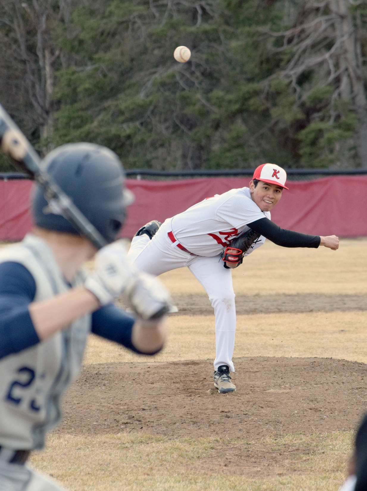 Kenai Central starter Carlos Caballero delivers to Soldotna’s Jeremy Kupferschmid on Tuesday, May 7, 2018, at the Kenai Little League fields. (Photo by Jeff Helminiak/Peninsula Clarion)