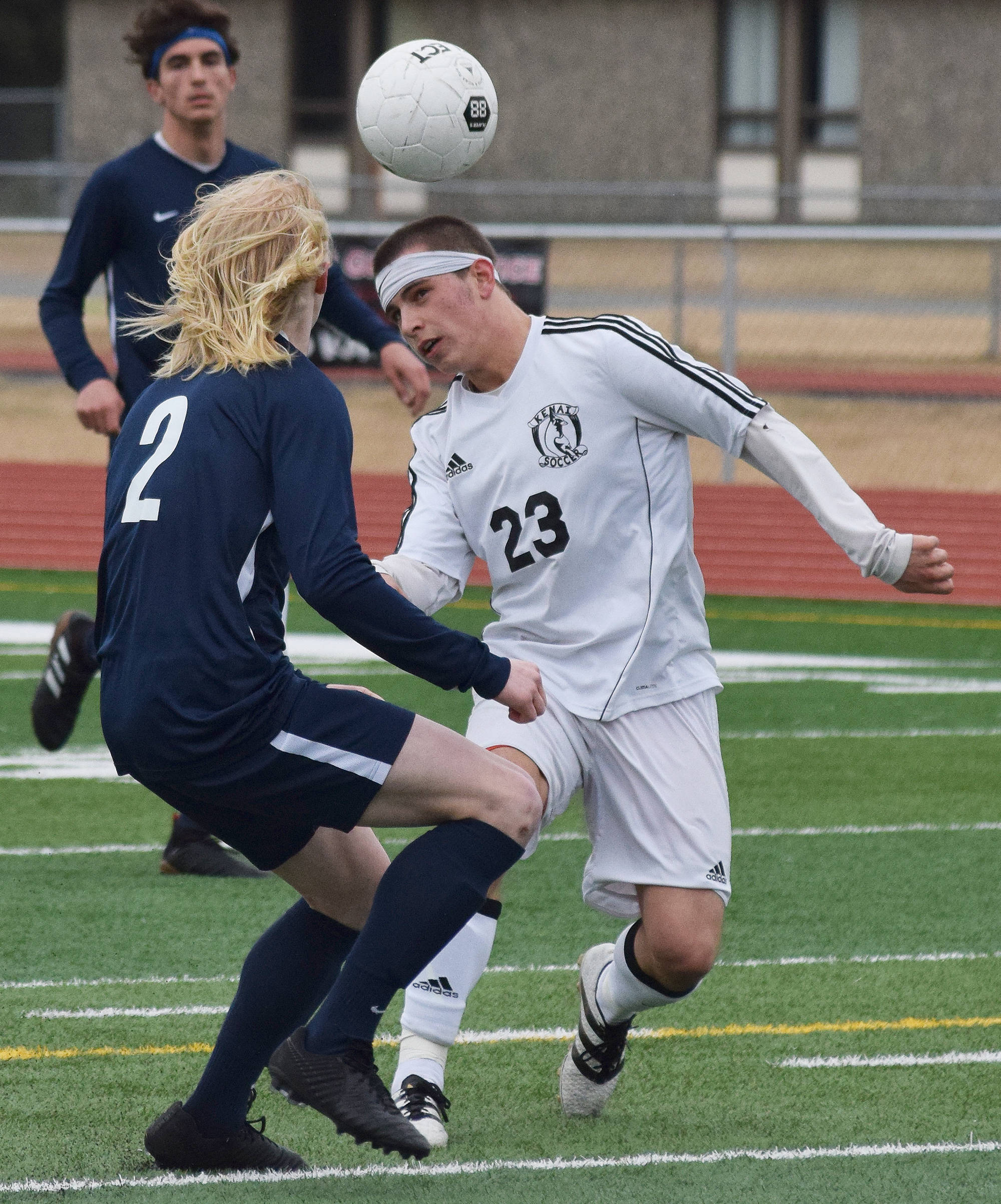 Kenai’s Zack Tuttle (23) and Homer’s Charles Rohr battle for a header Tuesday evening at Ed Hollier Field in Kenai. (Photo by Joey Klecka/Peninsula Clarion)