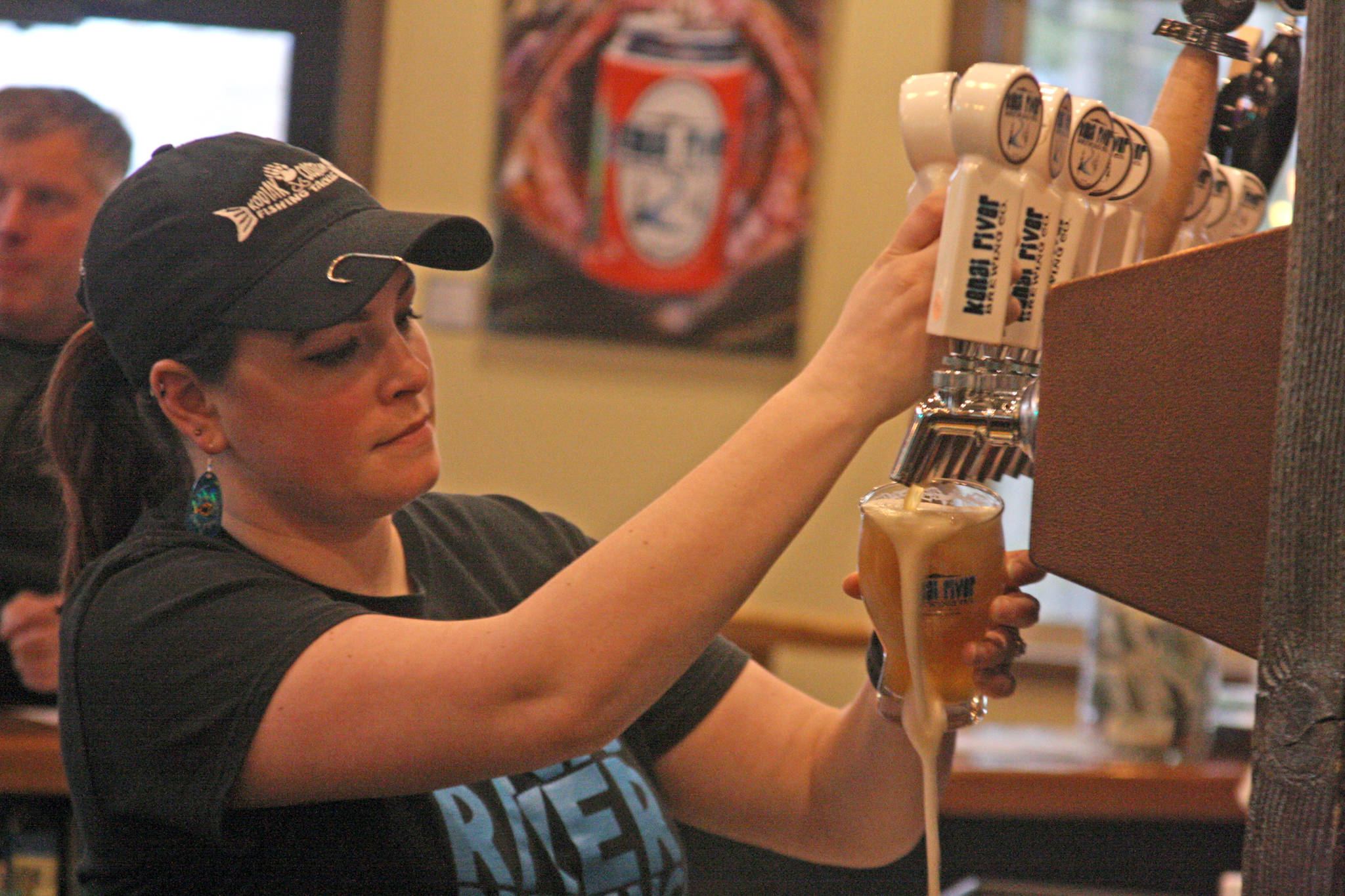 Bartender Kristin Dunn pours a beer in the taproom of Kenai River Brewing Company in Soldotna Wednesday. An amendment to legislation overhauling state alcohol regulations would reduce the amount of alcohol that can be legally served at breweries and distilleries by 12 ounces. (Photo by Erin Thompson/Peninsula Clarion)