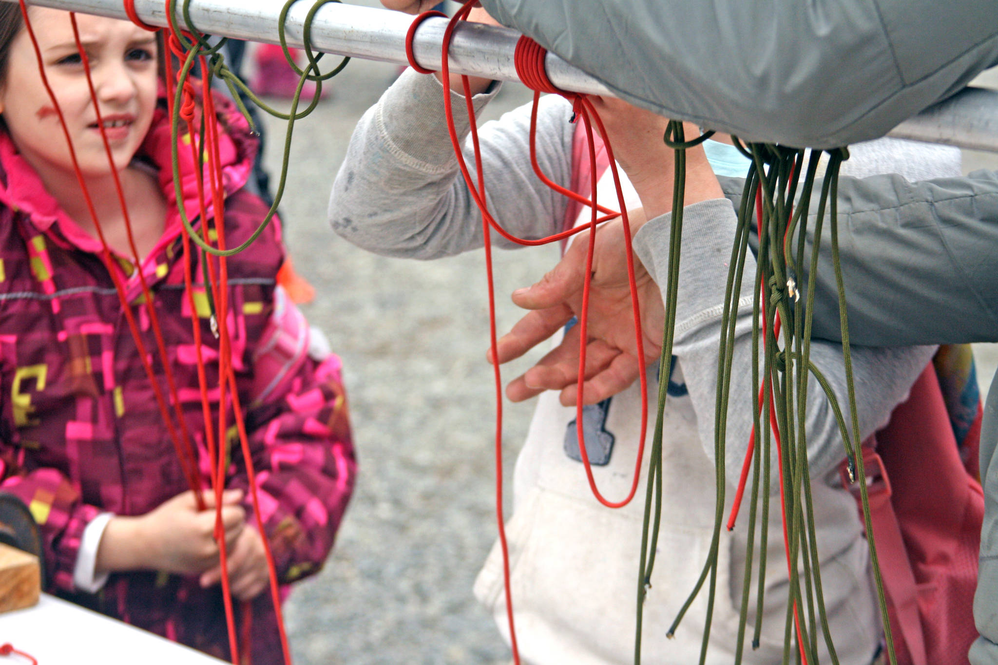 Students participate in a knot-tying demonstration during the 18th Annual Kenai Peninsula Salmon Celebration at Johnson Lake State Recreation Site in Kasilof. The fish-release event featured hands-on activity and demonstration booths focused around wildlife education and safety. (Photo by Erin Thompson/Peninsula Clarion)