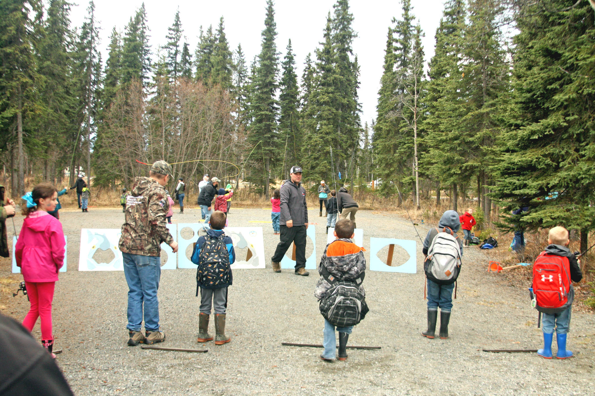 Kids try their hand at spin casting during the 18th Annual Kenai Peninsula Salmon Celebration at Johnson Lake State Recreation Site in Kasilof. The event featured hands-on activity and demonstration booths focused around wildlife education and safety. (Photo by Erin Thompson/Peninsula Clarion)