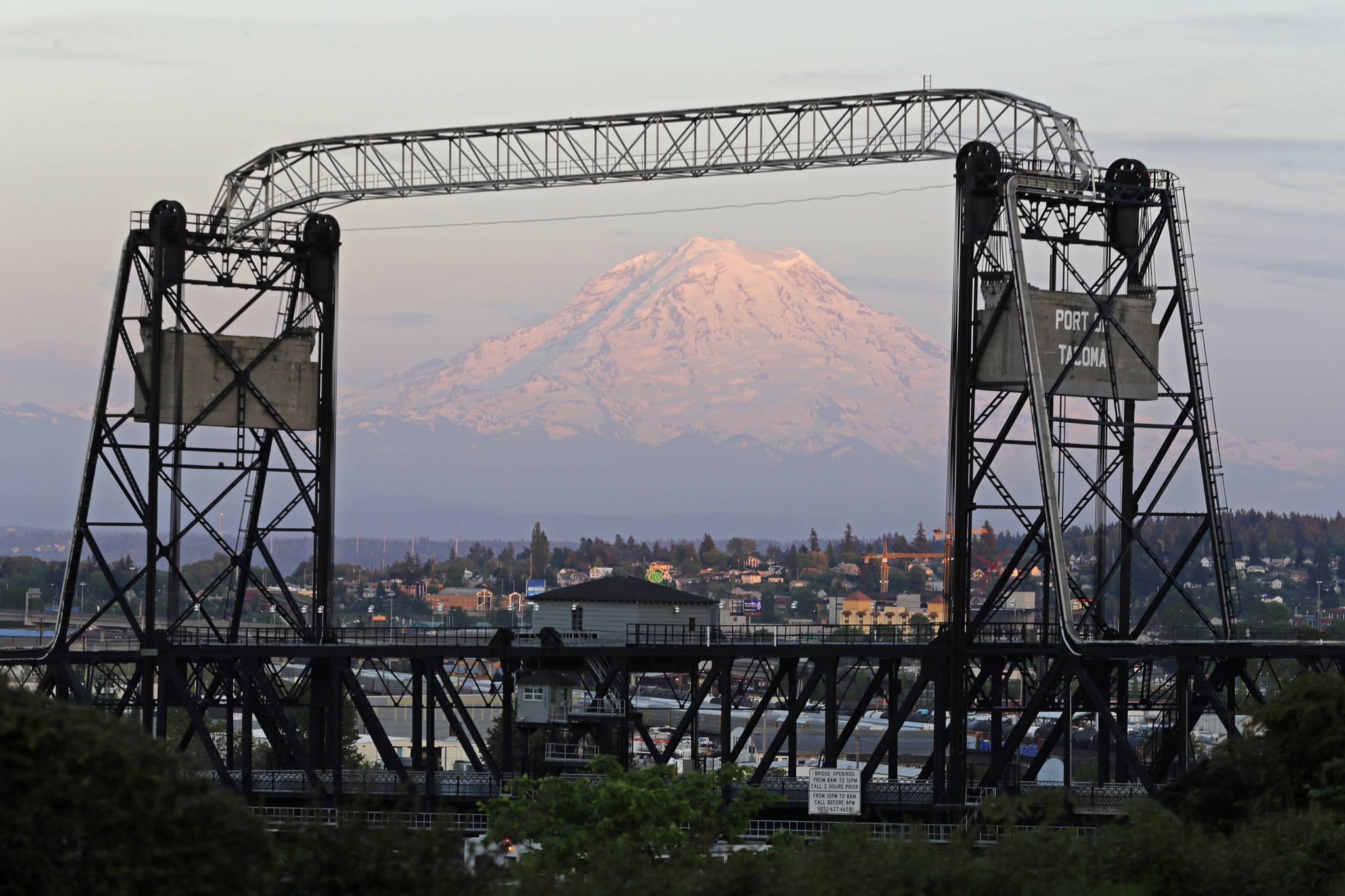 In this May 7, 2018 photo, Mount Rainier is seen at dusk and framed by the Murray Morgan Bridge in downtown Tacoma, Wash. The eruption of the Kilauea volcano in Hawaii has geologic experts along the West Coast warily eyeing the volcanic peaks in Washington, Oregon and California, including Rainier, that are part of the Pacific Ocean’s ring of fire. (AP Photo/Ted S. Warren)
