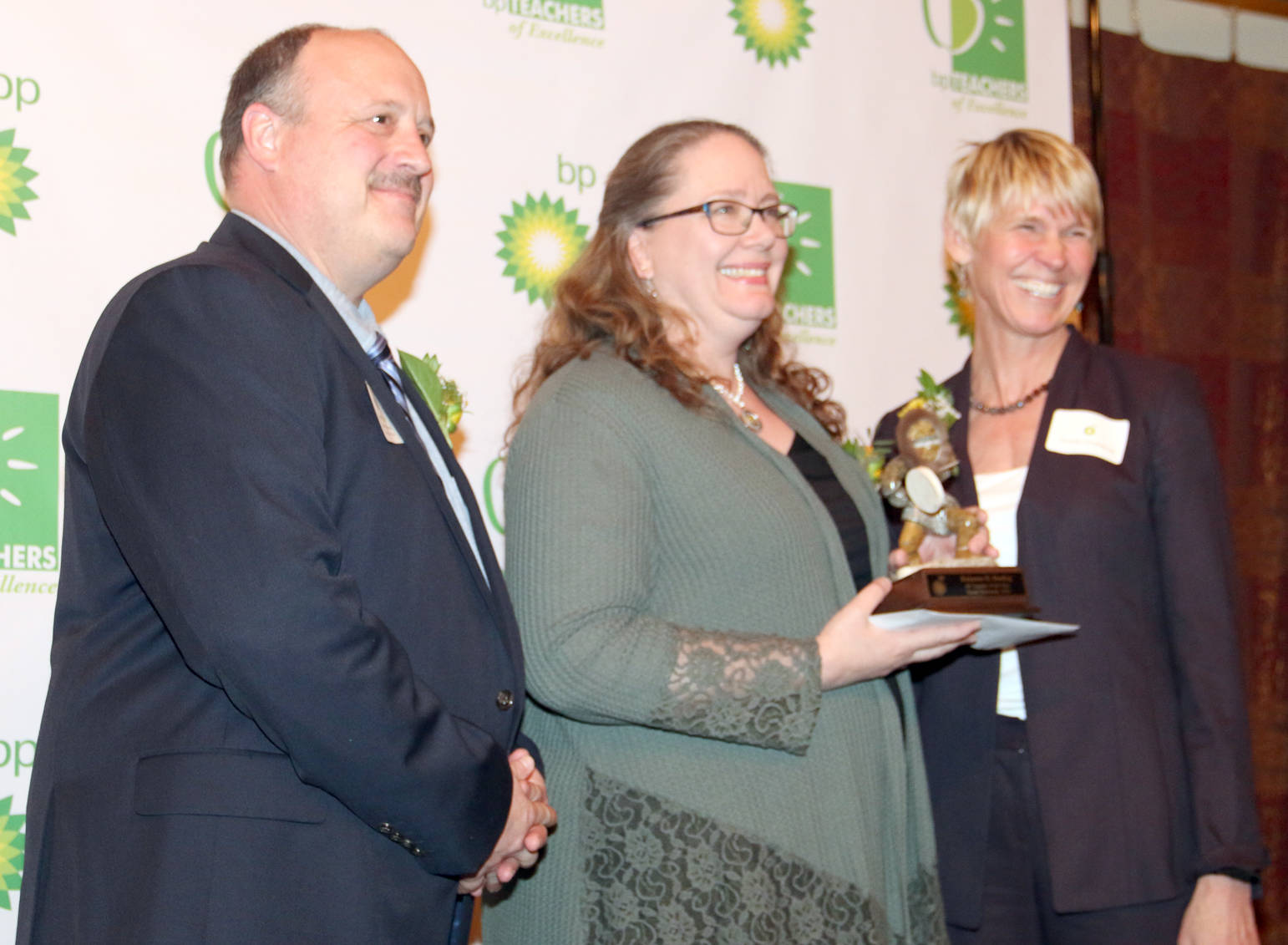 Supt. Sean Dusek and Wendy Lindskoog of BP congratulate Robanne Stading 2018 BP Teacher of the Year.