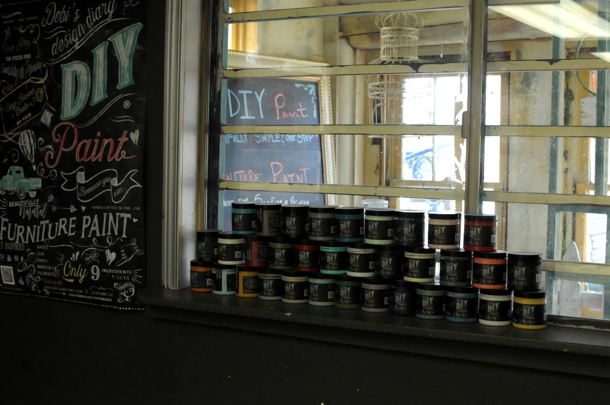 Organic clay-based paint stands stacked in the window at the “Art Shack,” an art studio space owned by Sue Mann, on Friday, May 4, 2018 in Soldotna, Alaska. Mann, who owns the art supply store Artzy Junkin on the lot next to the Maverick Bar, opened the space as a joint studio space for artists to teach classes or make art. It’s been a longtime goal she is starting this year, with classes like a mother and daughter chandelier-making class, mosaic, tie-dye and stained glass. She currently has five artists working on contract, she said. “Really, that’s my heart for this — bringing artists together,” she said.