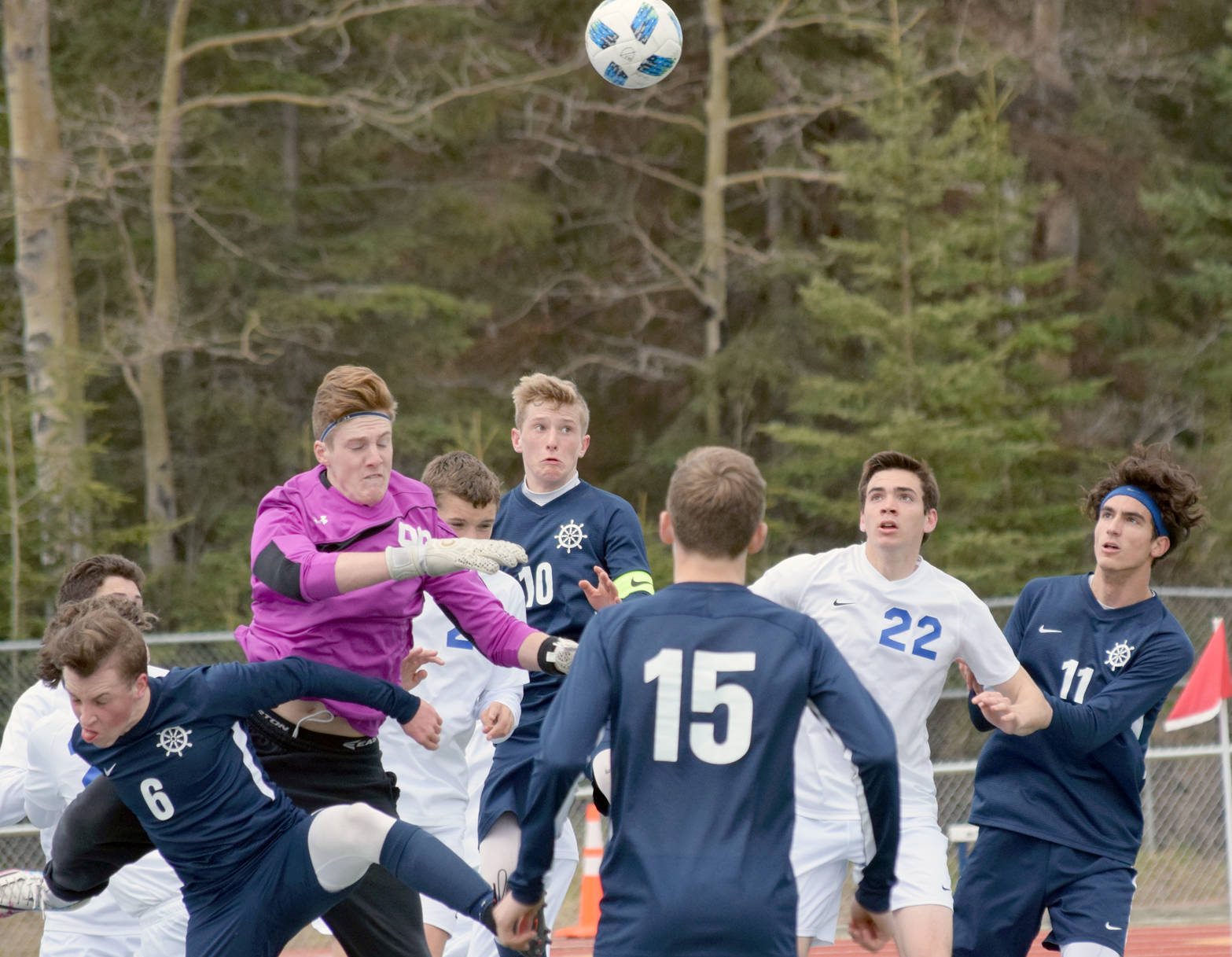 Soldotna goalie Cody Quelland punches the ball out of trouble Friday, May 18, 2018, against Homer in the Peninsula Conference tournament semifinals at Soldotna High School. (Photo by Jeff Helminiak/Peninsula Clarion)