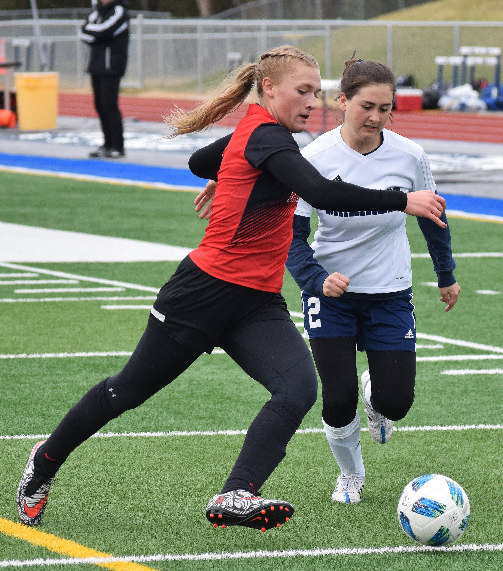 Kenai defender Damaris Severson (left) attempts to keep the ball away from Homer’s Raisa Basargin Friday in a Peninsula Conference tournament semifinal at Soldotna High School. (Photo by Joey Klecka/Peninsula Clarion)