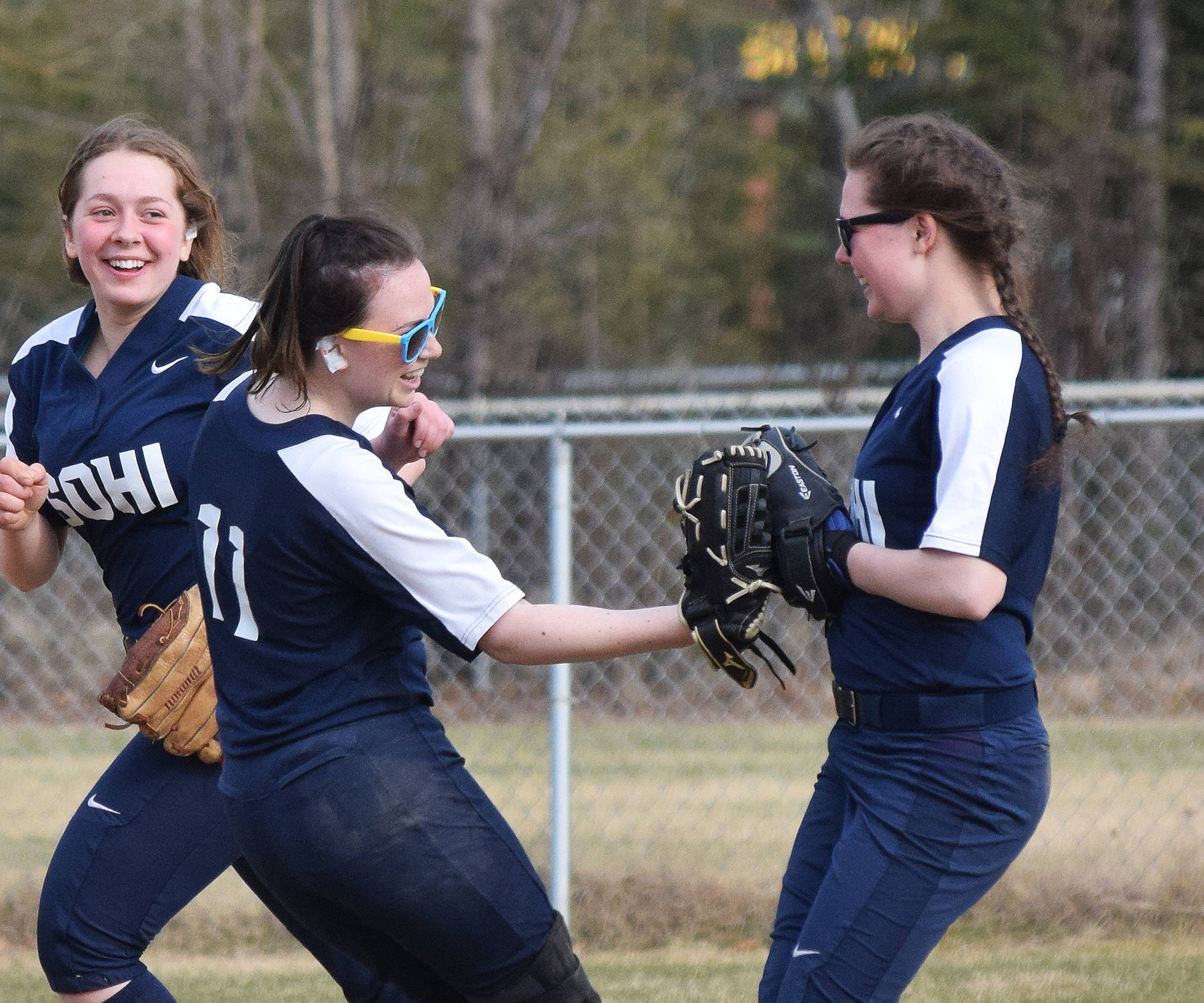 Soldotna pitcher Taralynn Frates (11) gives kudos to teammate Casey Card for making a great save Friday in a Northern Lights Conference contest against Kenai Central at the Soldotna softball fields. (Photo by Joey Klecka/Peninsula Clarion)