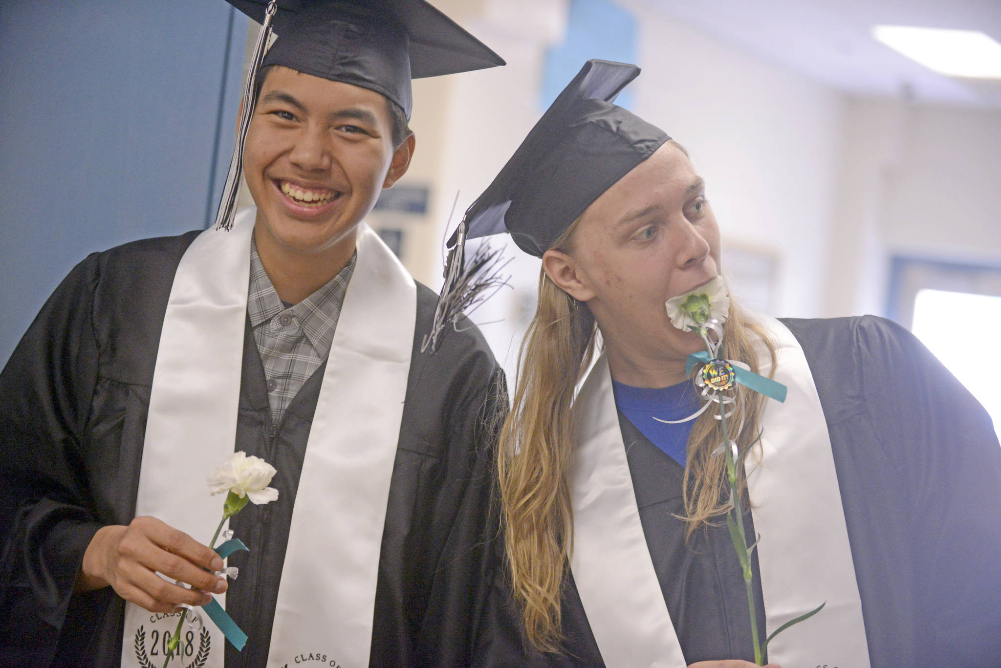 Graduate Henry Heft, left, jokes with a friend ahead of the 2018 commencement ceremony at Nikiski High School on Wednesday. Heft will begin a five-year stint in the U.S. Army in June. (Photo by Erin Thompson/Peninsula Clarion)