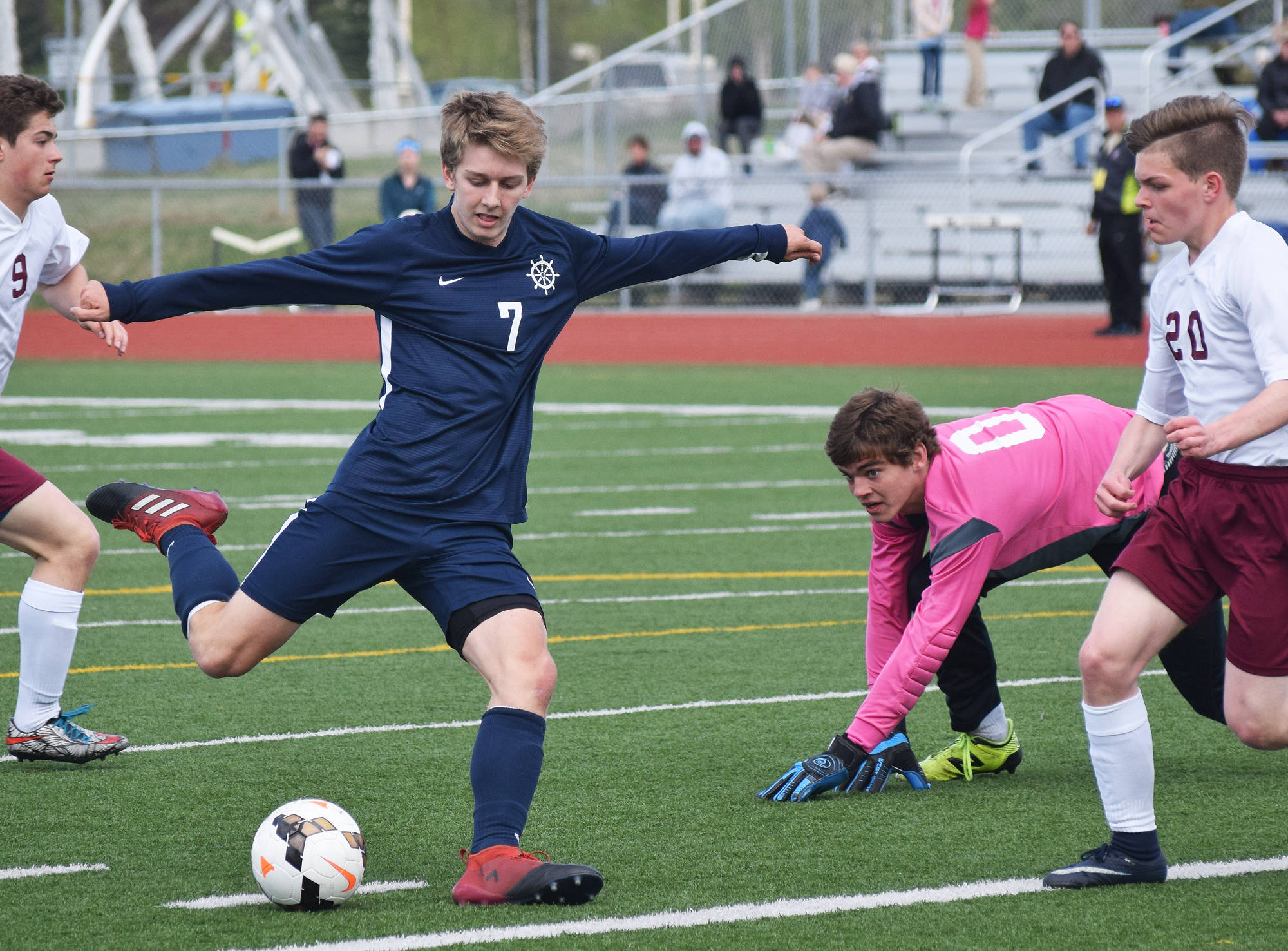 Homer’s Simon Dye (7) winds up for a goal scoring kick Thursday against Grace Christian in Division II soccer tournament play at Eagle River High School. (Photo by Joey Klecka/Peninsula Clarion)