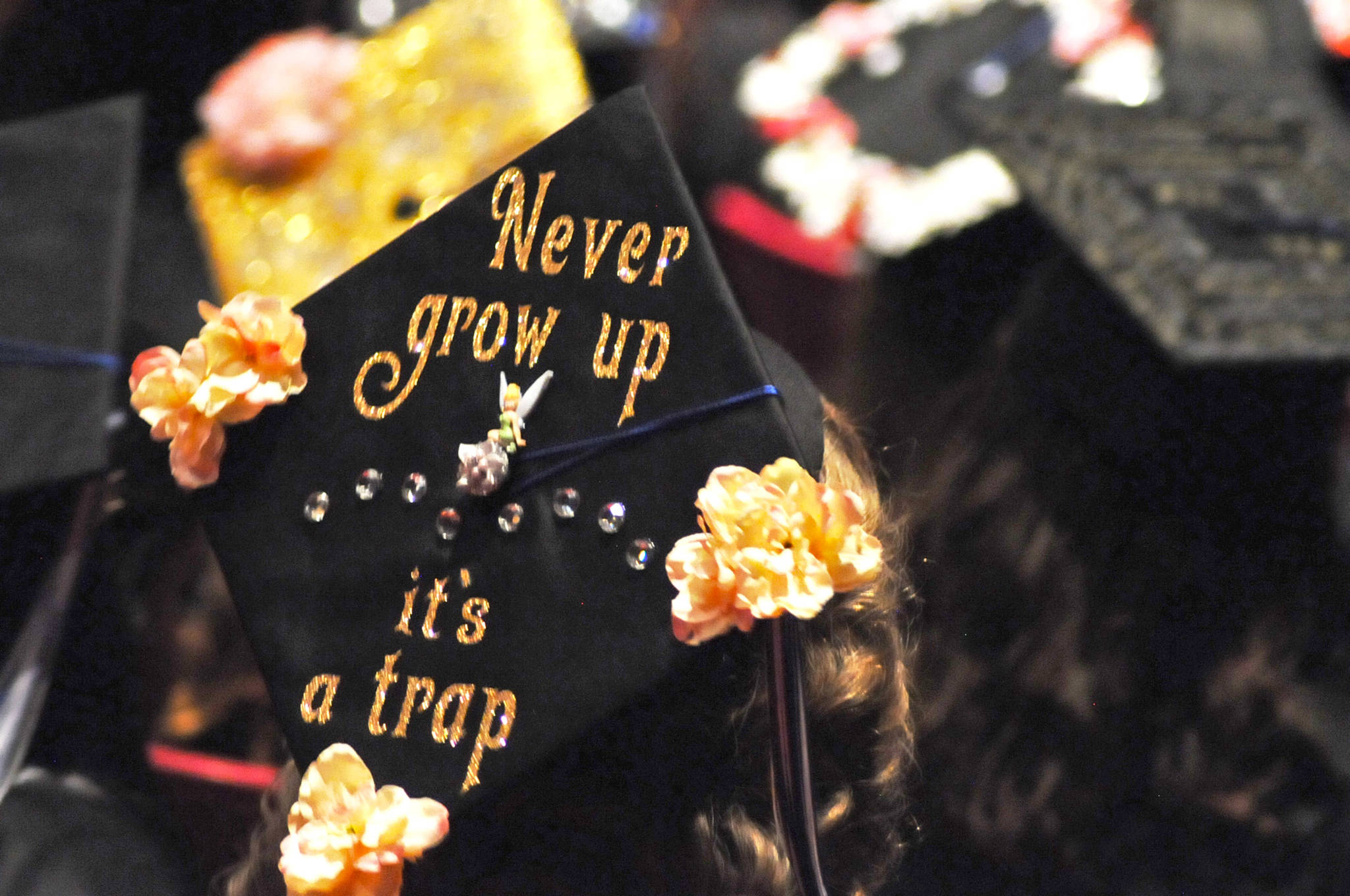 A Connections Homeschool graduate’s cap warns about the dangers of growing up at the program’s graduation ceremony on Thursday, May 24, 2018 in Soldotna, Alaska. The program, administered through the Kenai Peninsula Borough School District, graduated 58 students this year. (Photo by Elizabeth Earl/Peninsula Clarion)