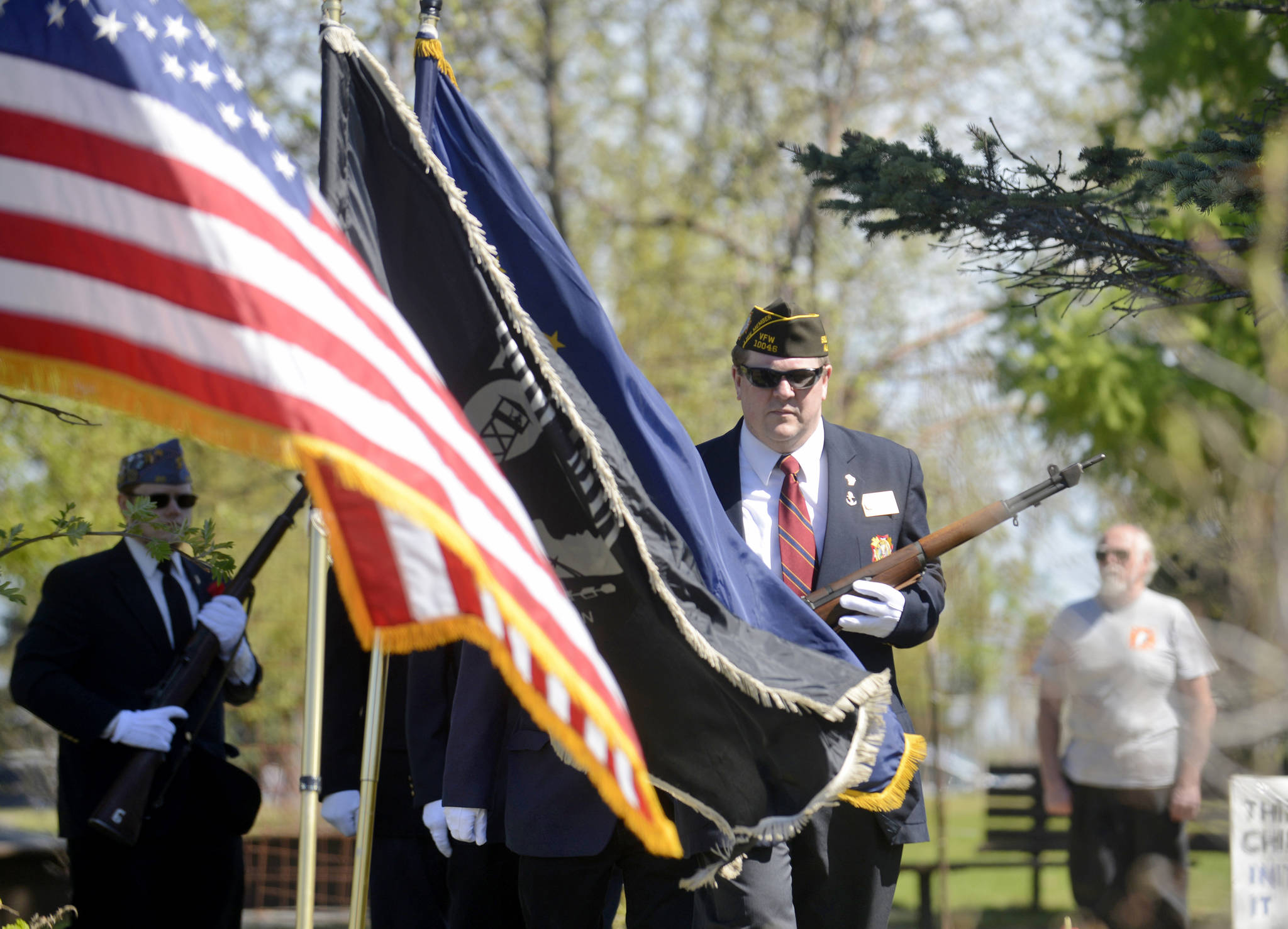 John Walker, Commander of the Veterans of Foreign Wars Soldotna post, leads the color guard in retiring the colors at a Memorial Day ceremony at Leif Hansen Memorial Park on Monday, May 28 in Kenai, Alaska. (Ben Boettger/Peninsula Clarion)