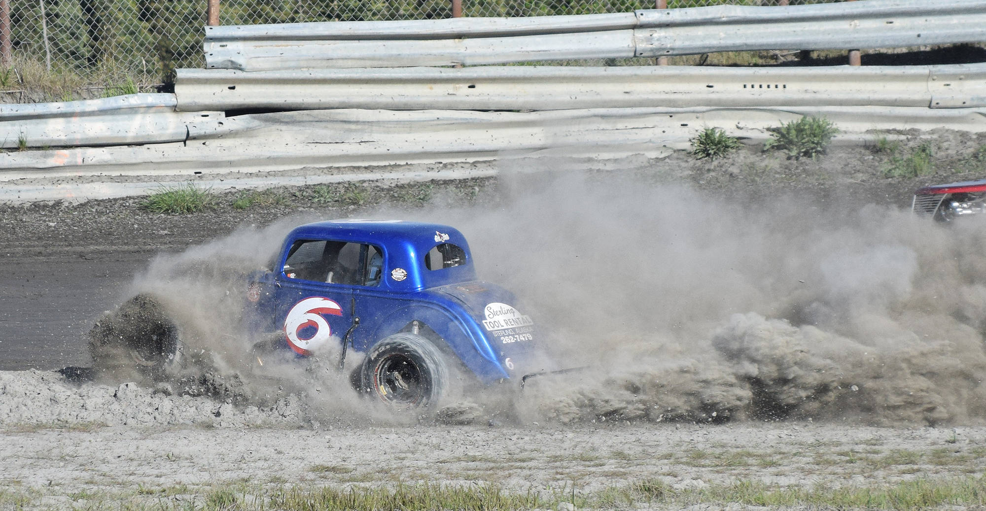Legends driver Brent Roumagoux spins into the dirt Saturday night at Twin City Raceway in Kenai. (Photo by Joey Klecka/Peninsula Clarion)