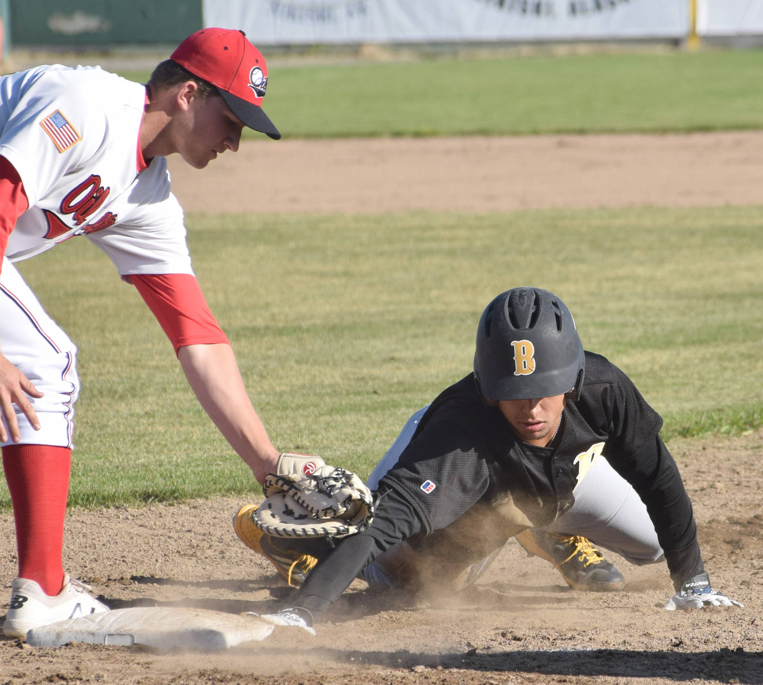 Oilers first baseman Michael Young applies a late tag to Dan Stankiewicz of the Anchorage Bucs in the second inning on Thursday, June 7, 2018, at Coral Seymour Memorial Park in Kenai. (Photo by Jeff Helminiak/Peninsula Clarion)