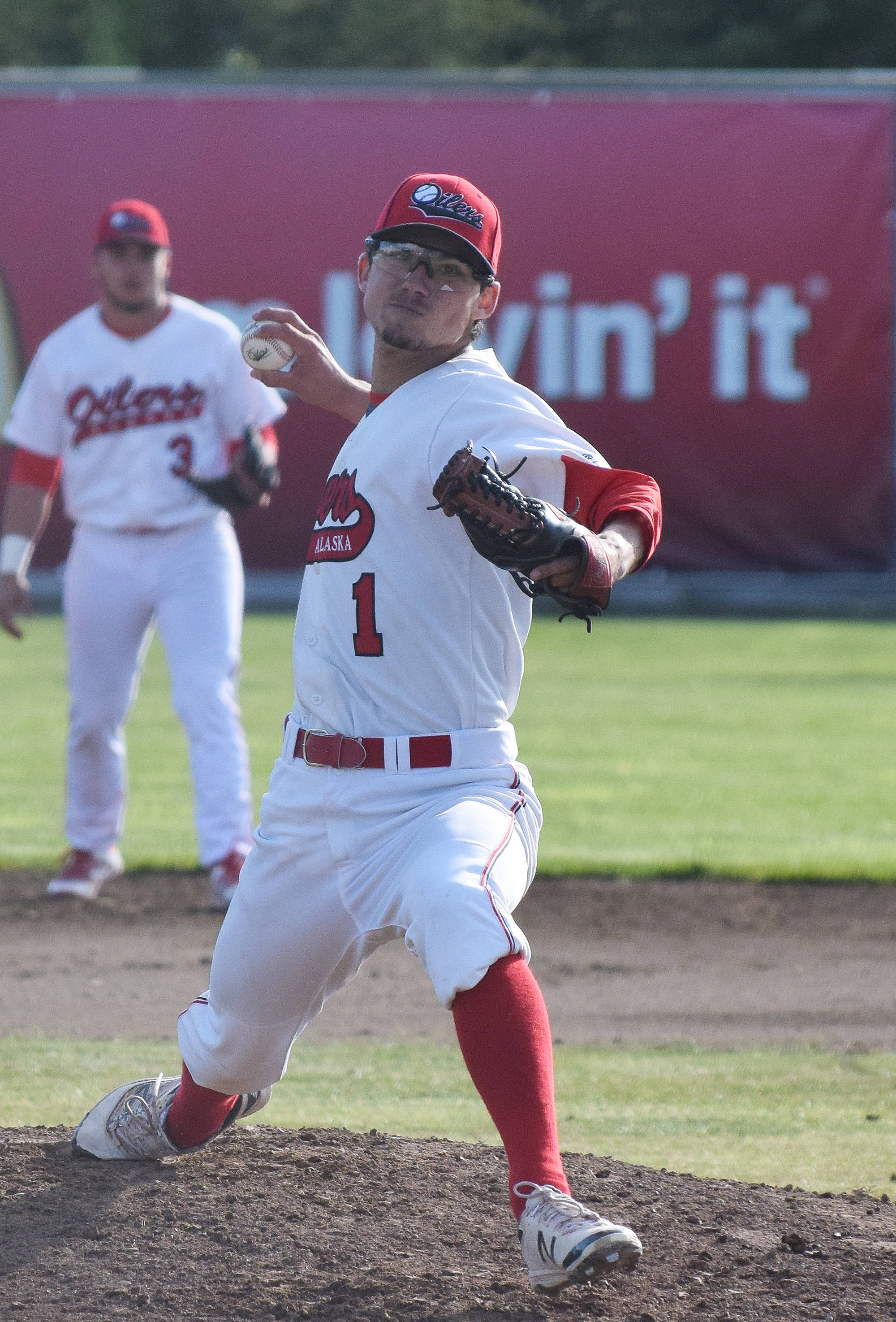 Peninsula Oilers pitcher Austin Merrill delivers a pitch June 8, 2018, against the Anchorage Bucs at Coral Seymour Memorial Ballpark in Kenai. (Photo by Joey Klecka/Peninsula Clarion)