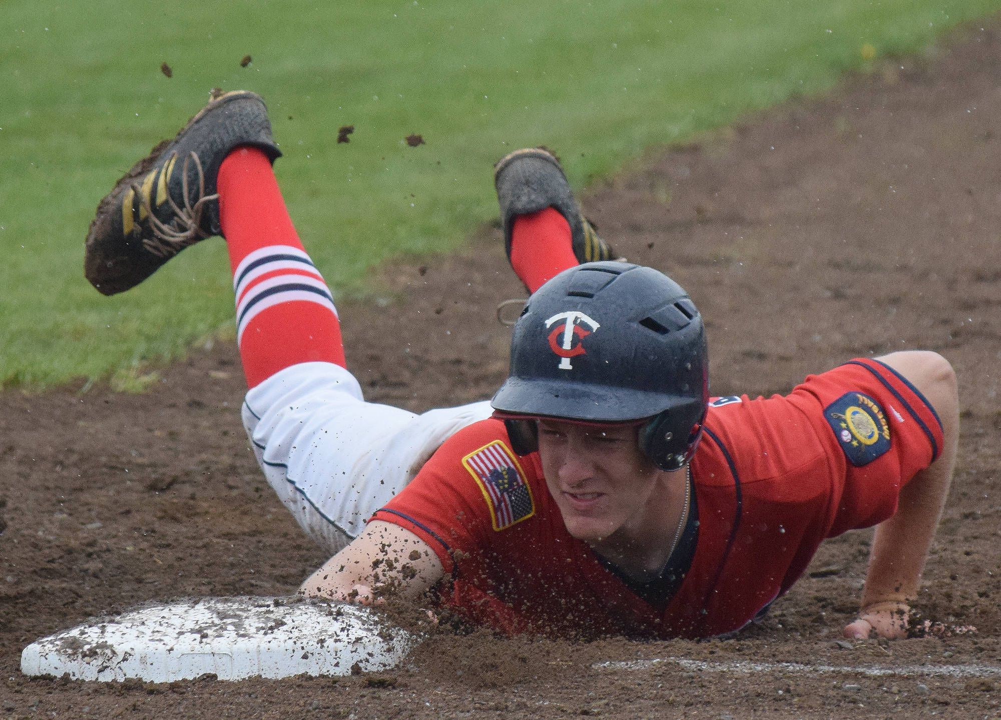 Twins catcher Cody Quelland tags to first base Friday afternoon against Service at Coral Seymour Memorial Ballpark in Kenai. (Photo by Joey Klecka/Peninsula Clarion)