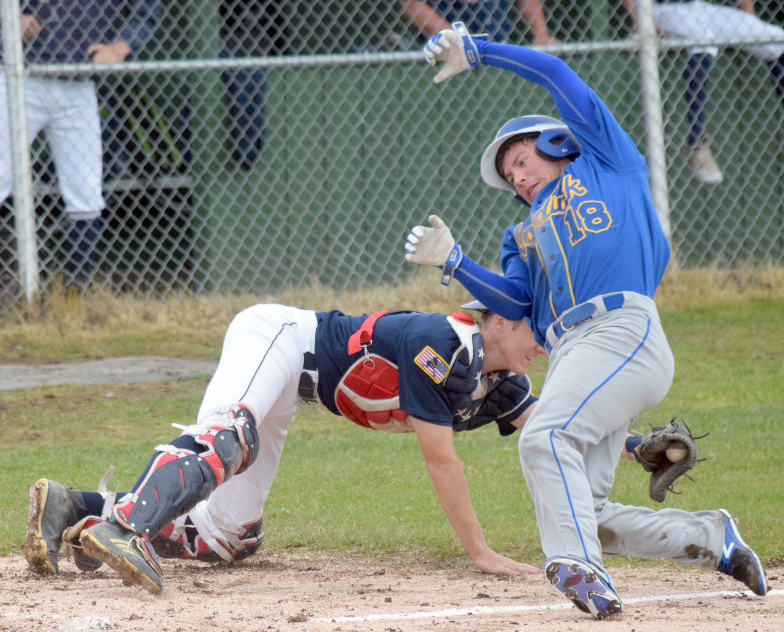 Kodiak’s Anders Hocum avoids the tag of Twins catcher Cody Quelland to score in the fourth inning Saturday, June 16, 2018, at Kenai Little League fields. (Photo by Jeff Helminiak/Peninsula Clarion