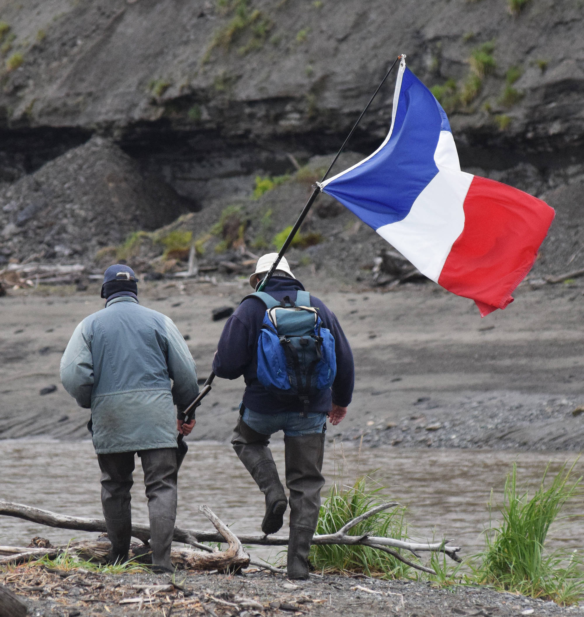 Jean-Philip Hullen and Pierre Morell walk with the French national flag Saturday at the fourth annual Clam Scramble 5K in Ninilchik. (Photo by Joey Klecka/Peninsula Clarion)